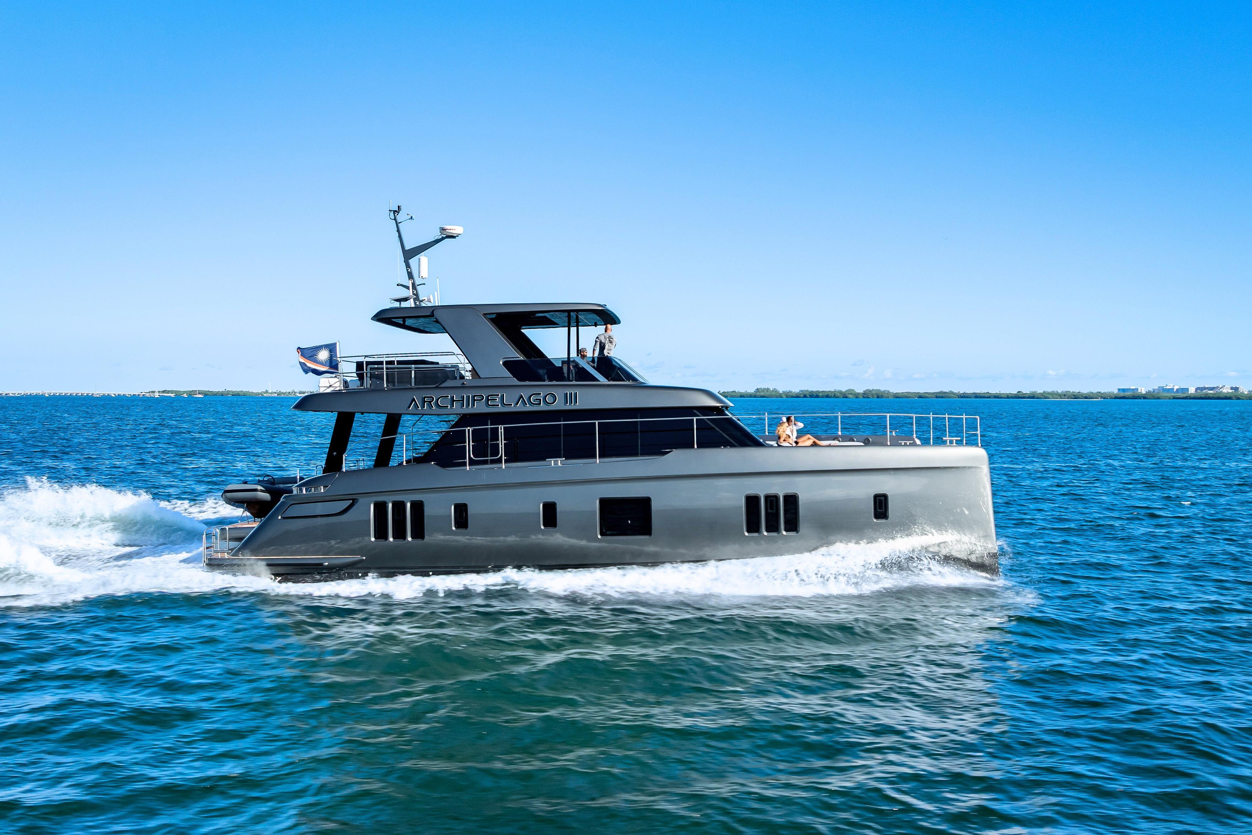 2026 Sunreef 60 Power yacht cruising on open water under clear blue skies.