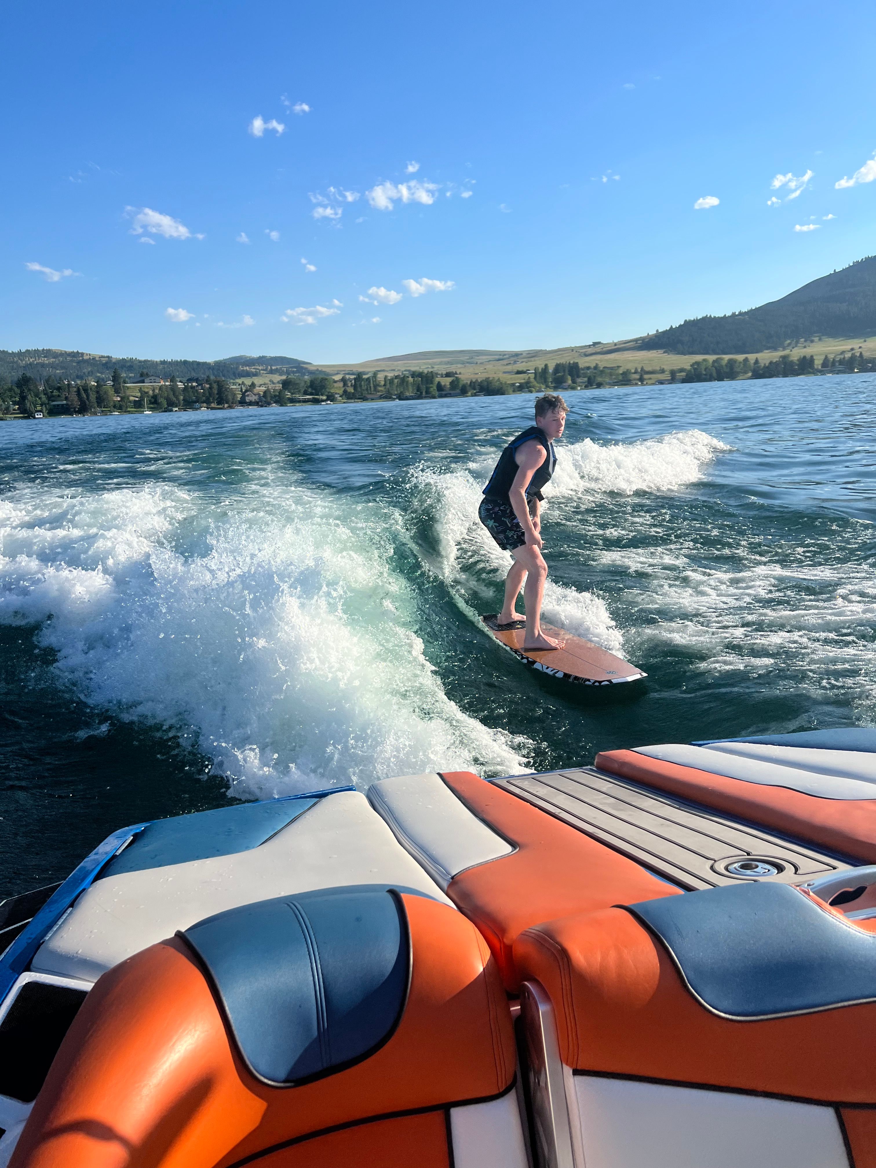 Person surfing behind a 2013 MasterCraft XStar boat.