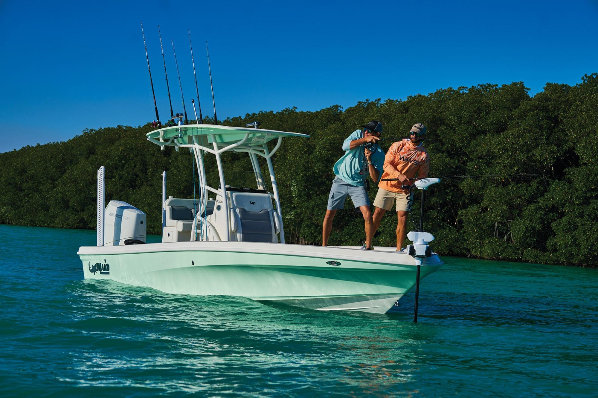 Two people fishing on a 2026 Mako 24 APEX boat in clear blue water.