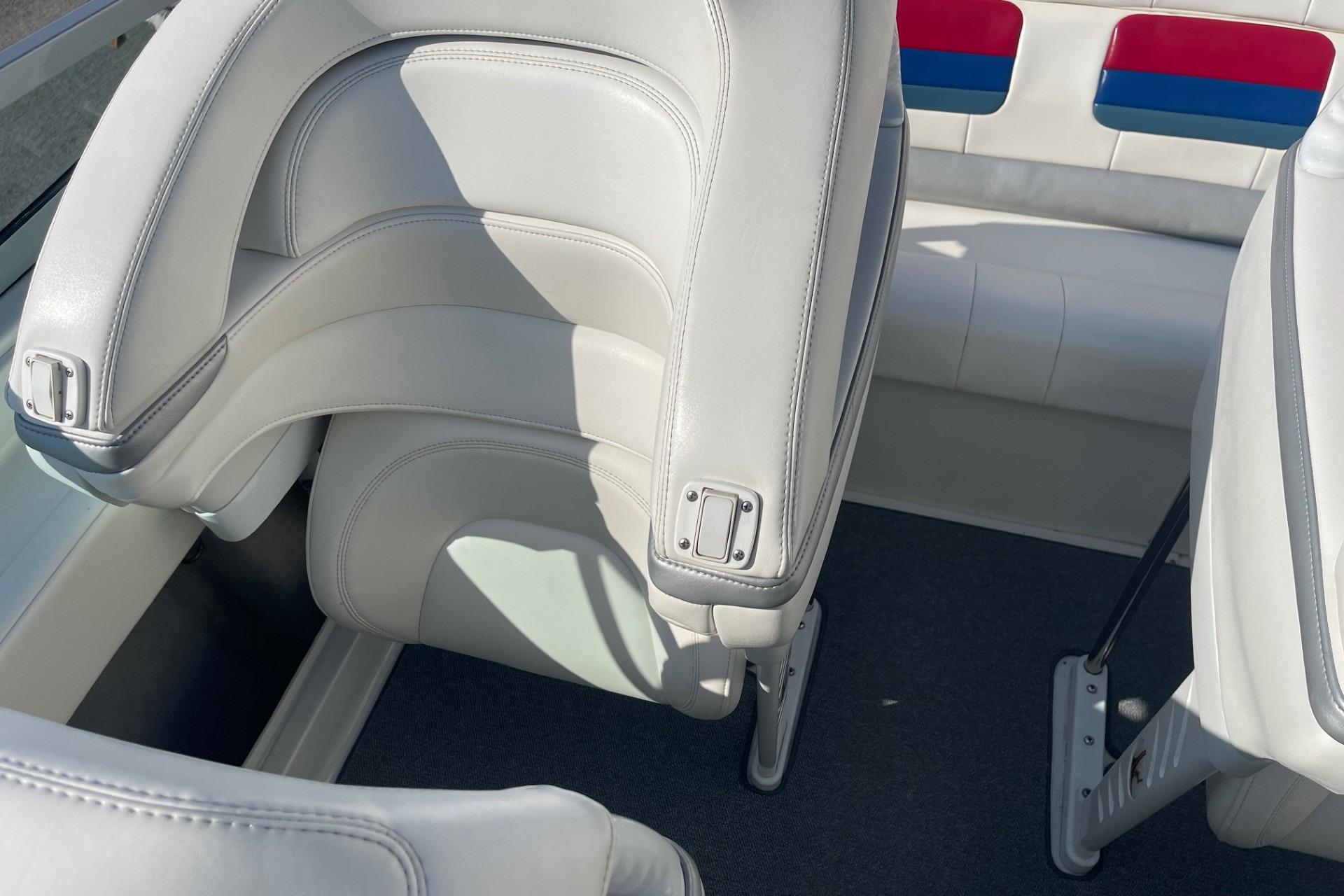 2004 Formula 382 FASTech boat interior with white leather seats and colorful accents.