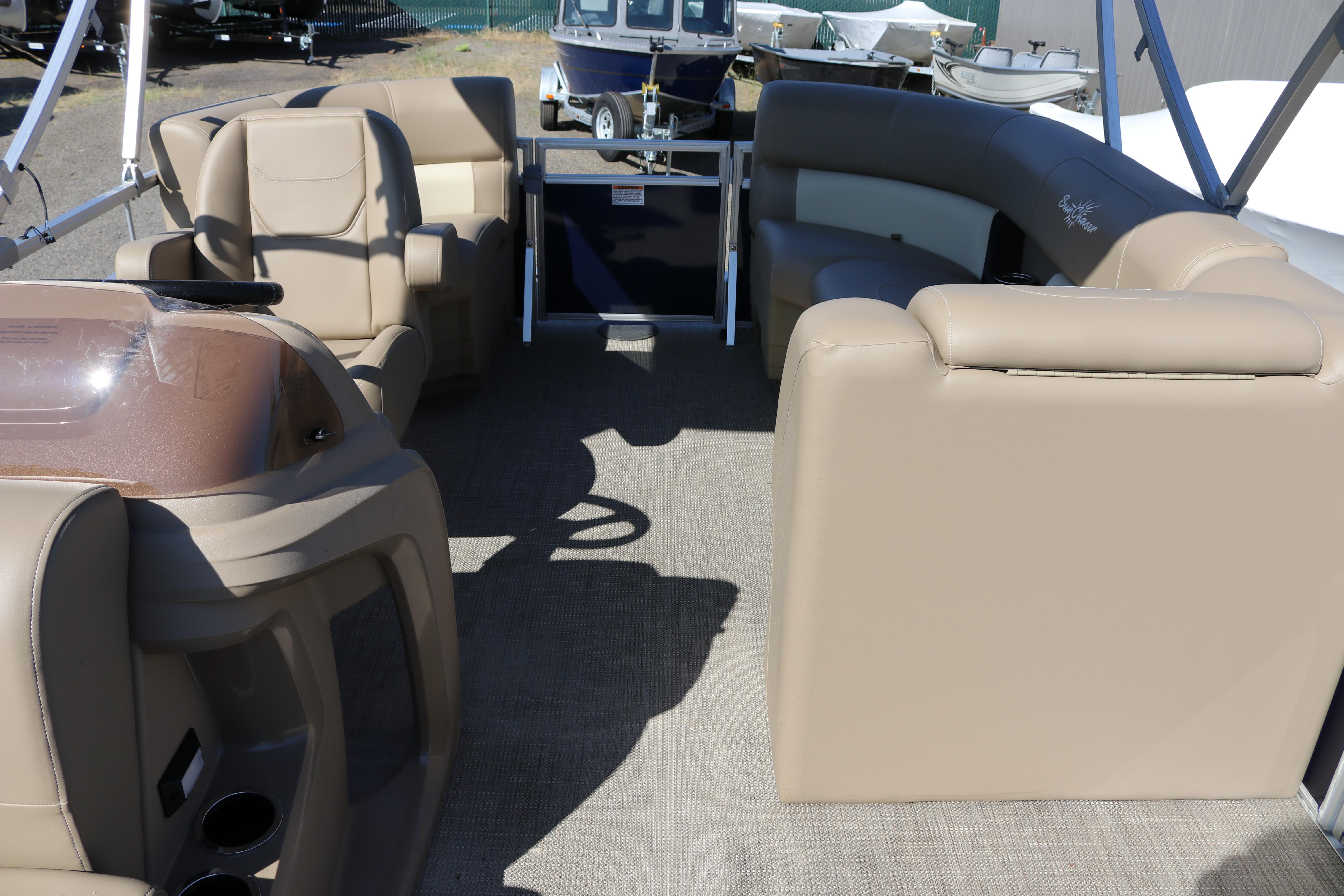 Interior of 2025 Sun Chaser Vista Fish 18 pontoon boat with beige seating.