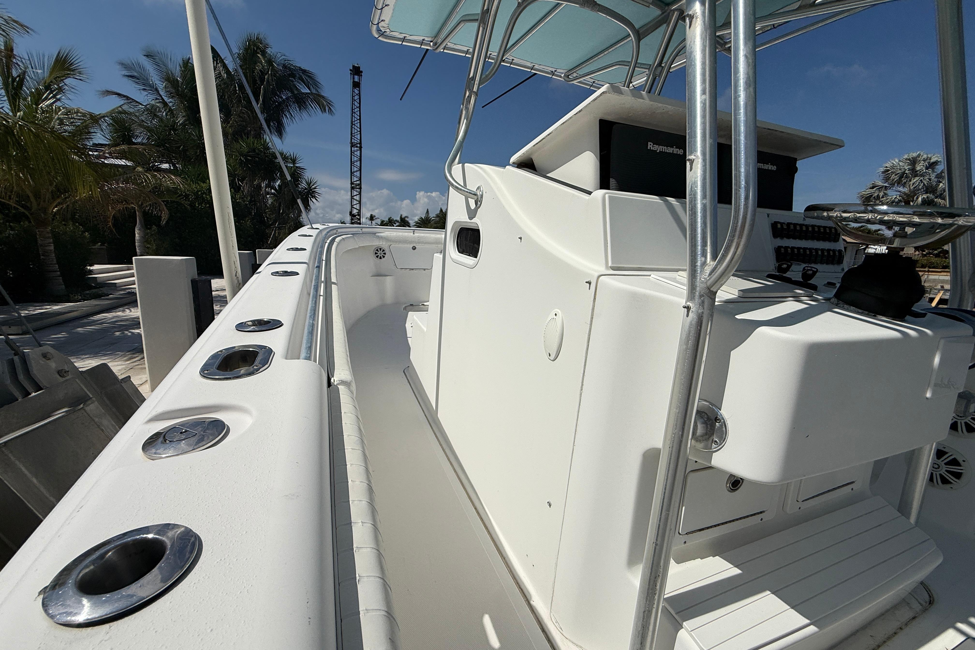 2003 Palmetto 33 Adventure boat with sleek white deck and modern controls.