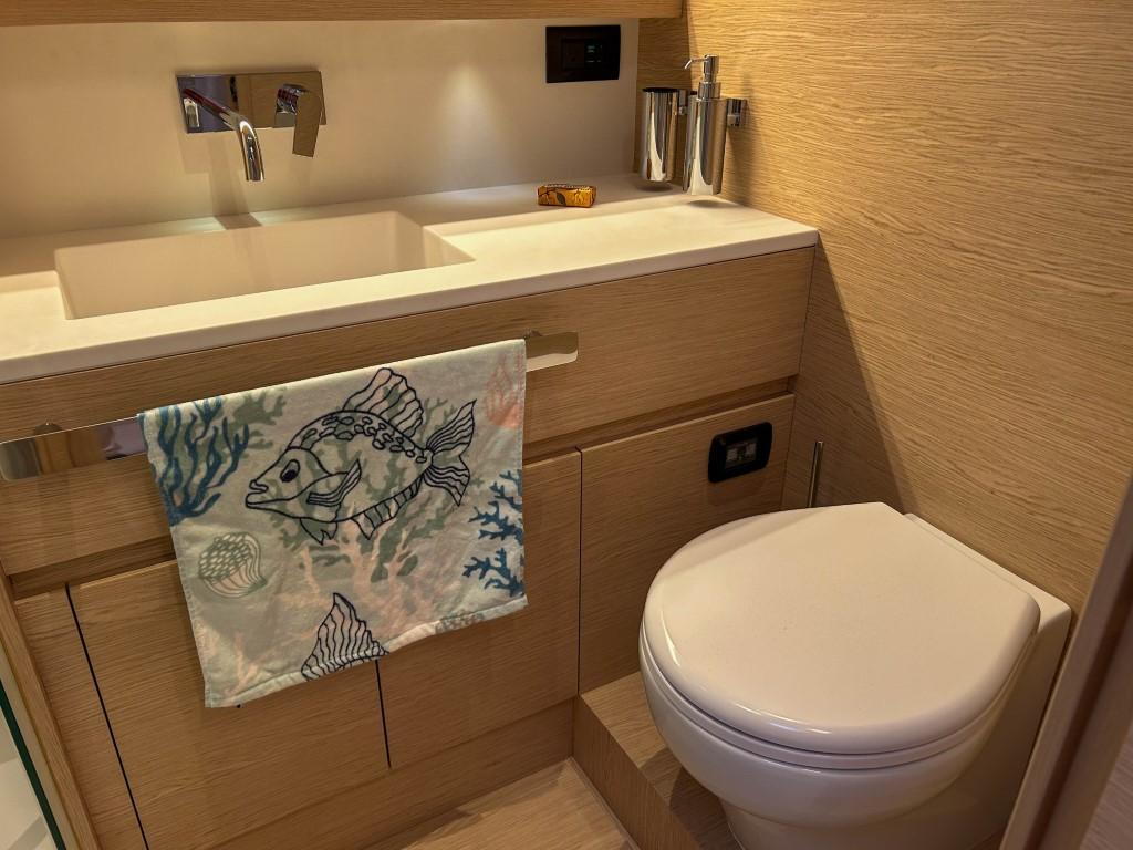 Modern bathroom in 2024 Solaris Power 52 Open yacht with sink and toilet.