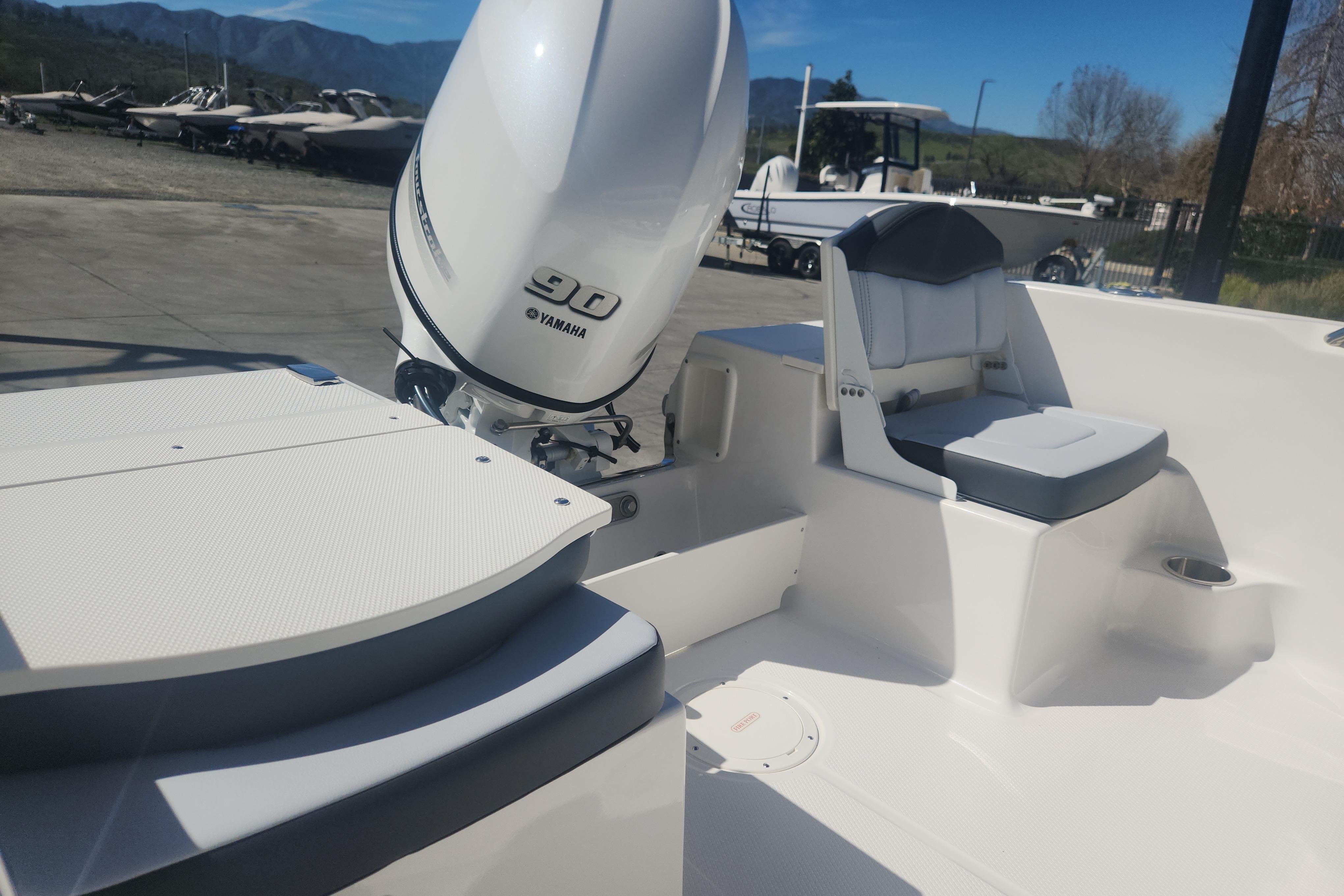 2026 Robalo R160 Center Console boat with Yamaha 90 engine, outdoor setting.