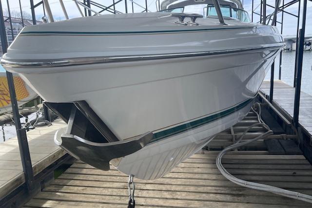 1999 Formula 400 Super Sport boat docked, showcasing sleek white hull design.