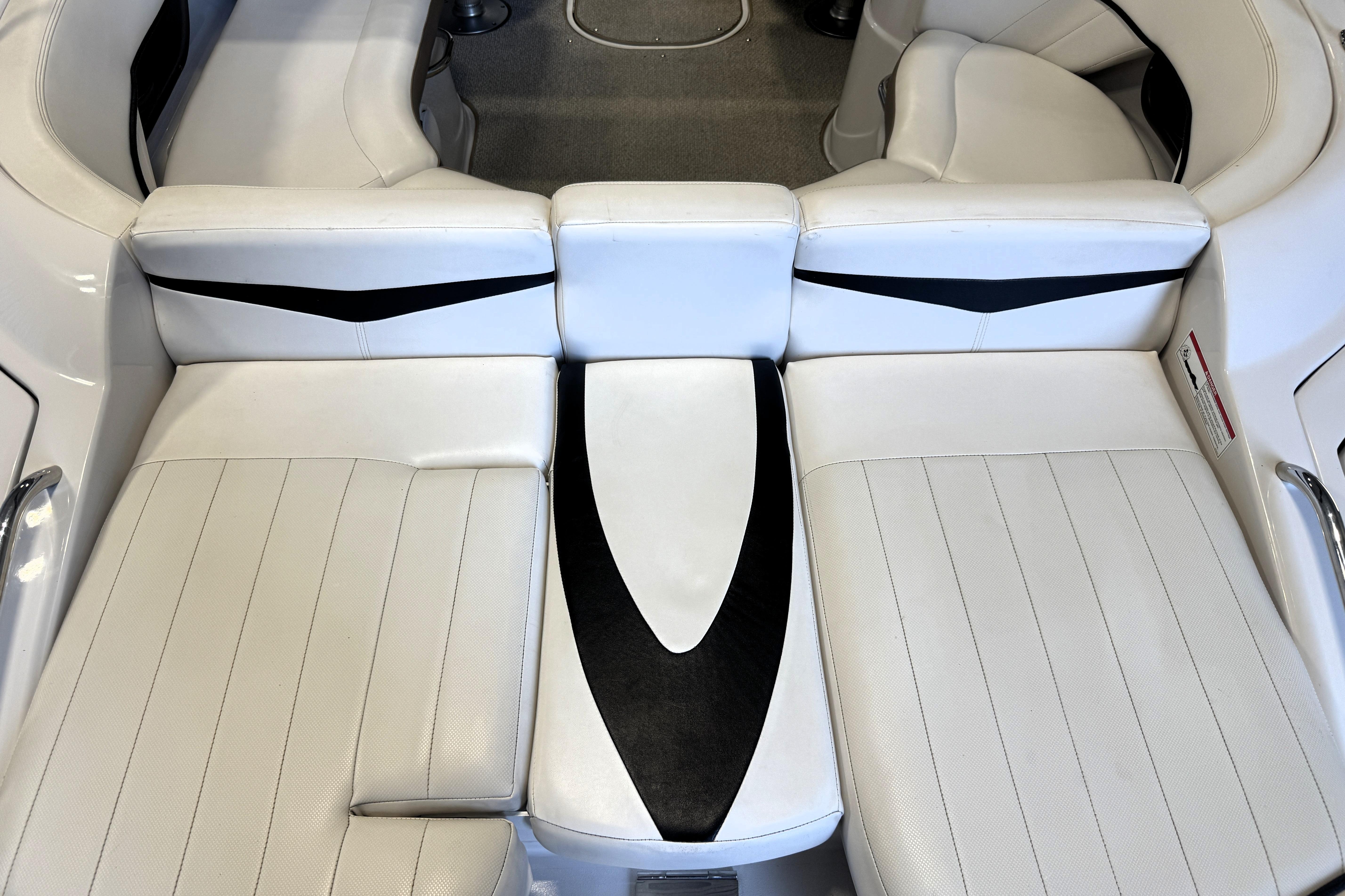 2008 Four Winns H240 boat interior with white cushioned seating and black accents.
