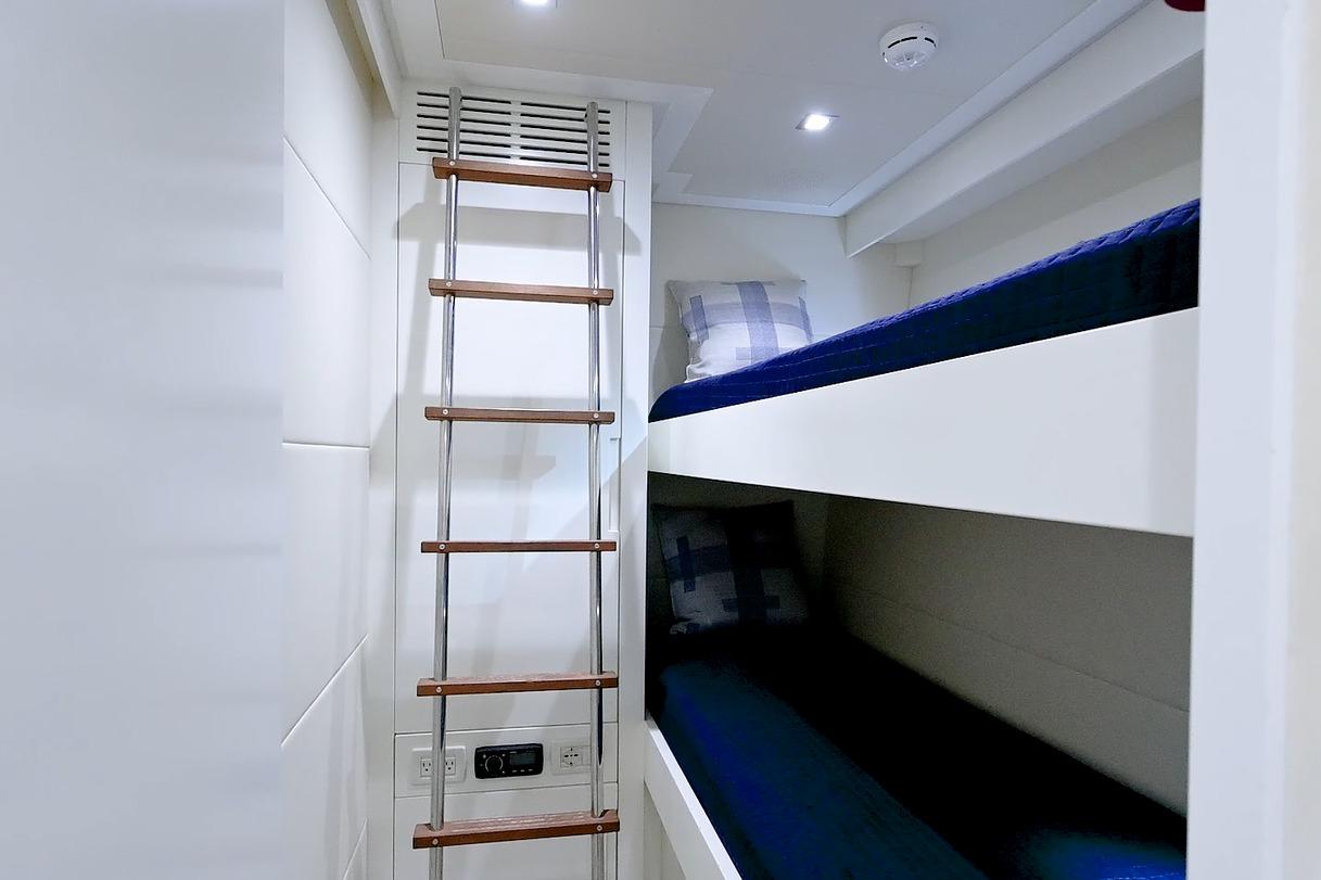 Bunk beds with ladder in 2015 Pershing 92 yacht interior.