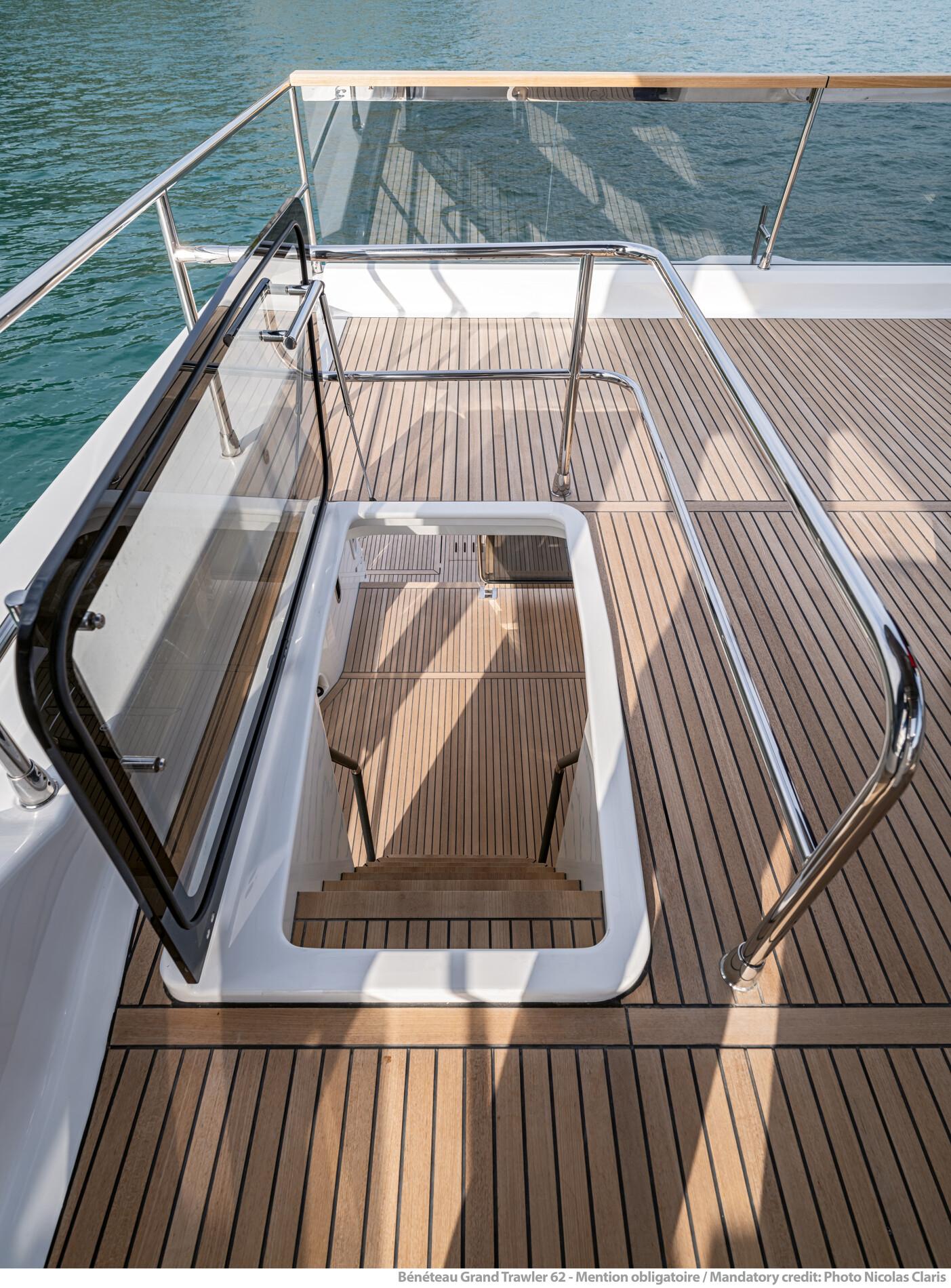 Beneteau Grand Trawler 62, 2025 model, featuring elegant teak deck and modern railing design.