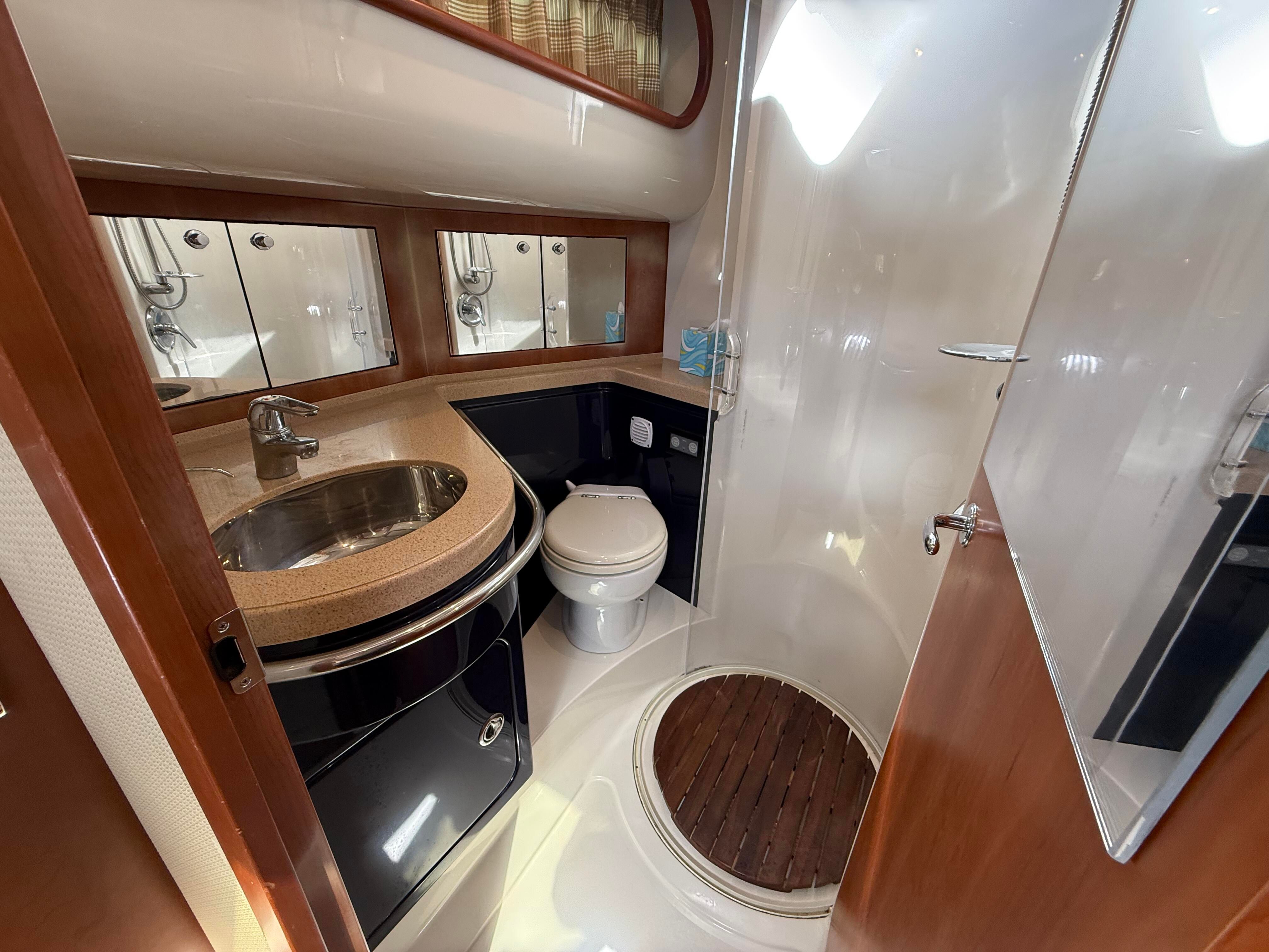 Bathroom in a 2007 Chris-Craft Roamer 40 with sink, toilet, and shower.