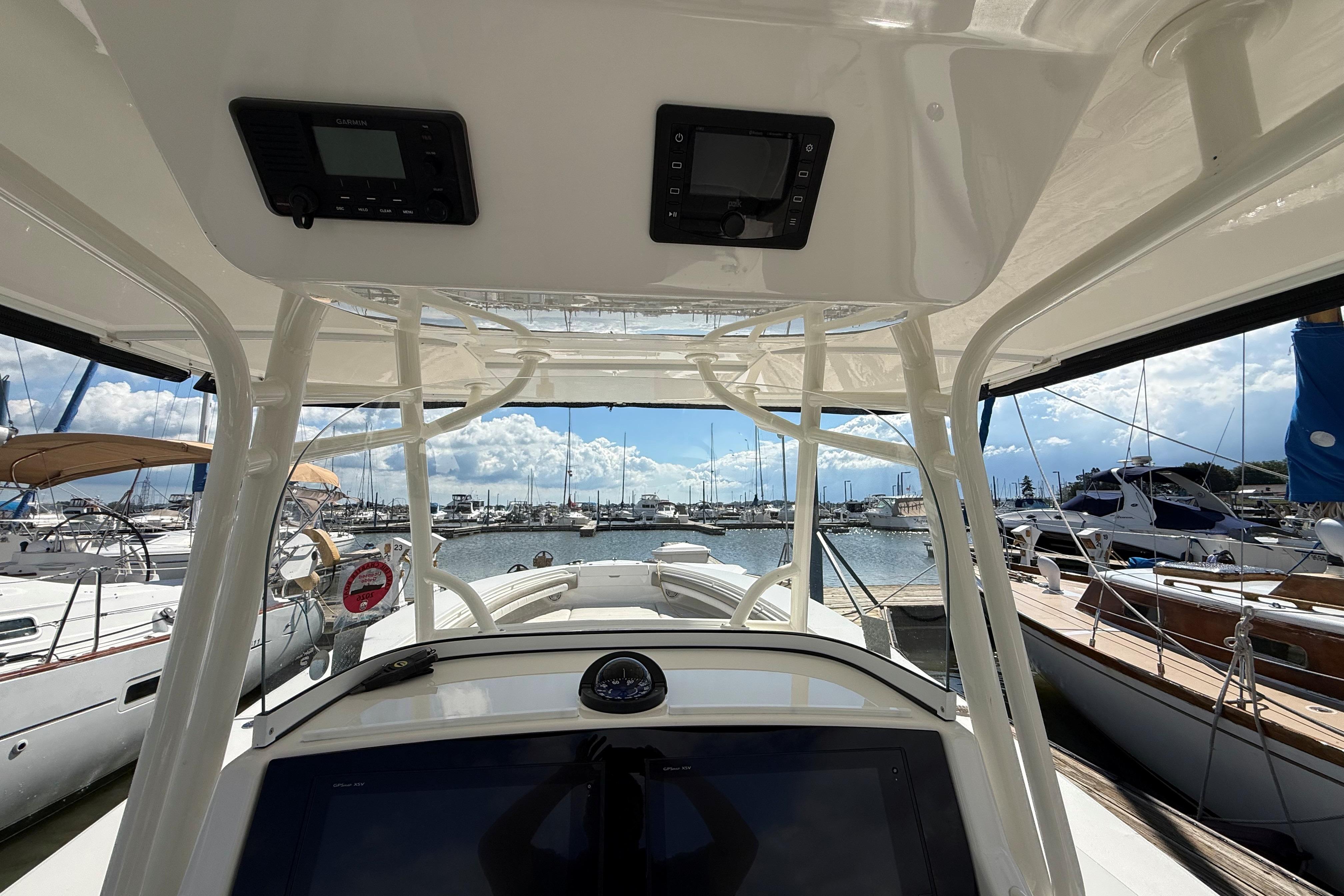2019 Regulator 34SS boat interior view at marina with clear sky and docked yachts.