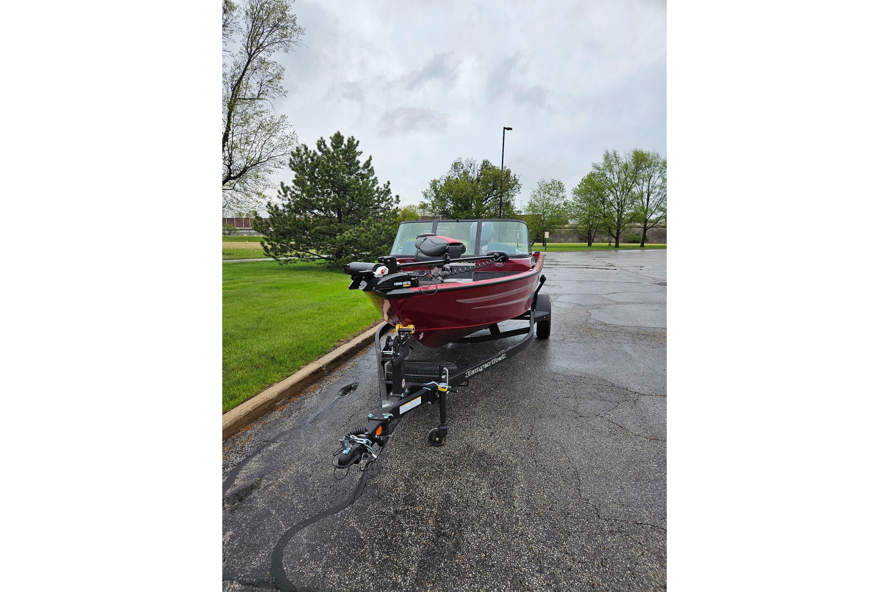 2026 Ranger VS1782SC Reata boat on trailer in parking lot, surrounded by trees.
