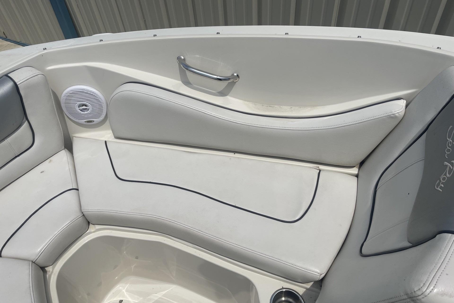 Interior seating of 2010 Sea Ray 230 Bow Rider Select boat, featuring white upholstery.