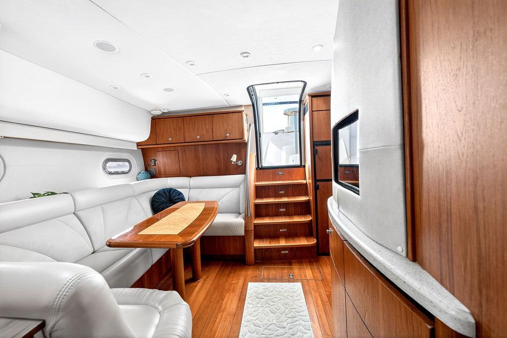 Luxurious interior of 2006 Tiara Yachts 4300 Sovran with elegant wood finishes and plush seating.