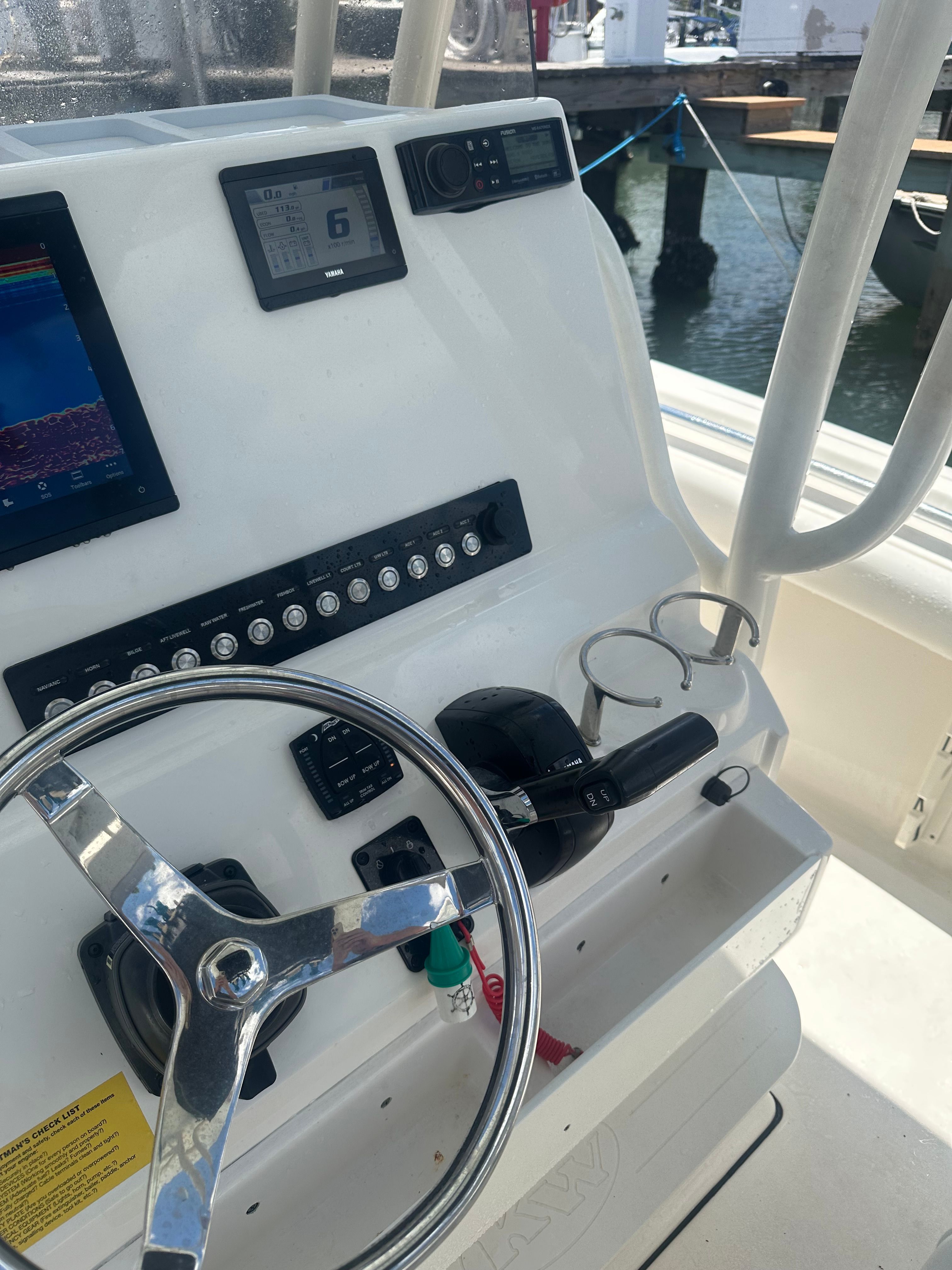 The helm of a Key West 219 FS boat with instruments and controls.