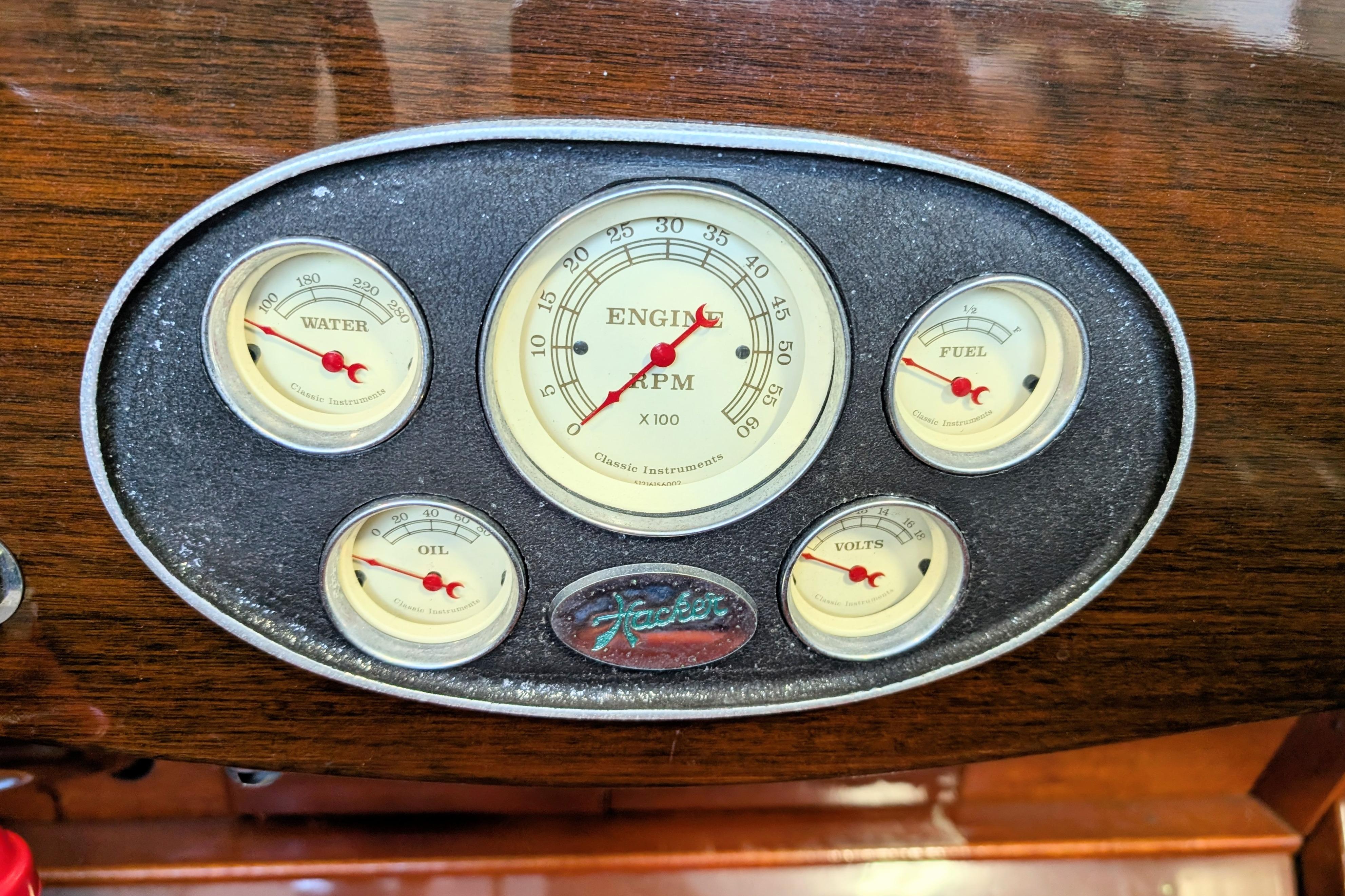 Vintage dashboard gauges of a 2001 Hacker-Craft 24 Dual Console boat.