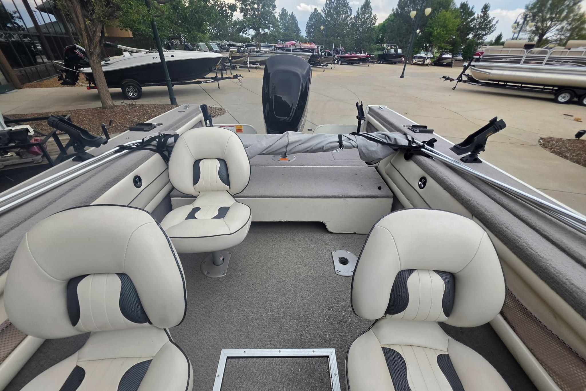 Interior of a 2010 Starcraft NexStar 1910 I/O boat with seating and fishing rod holders.