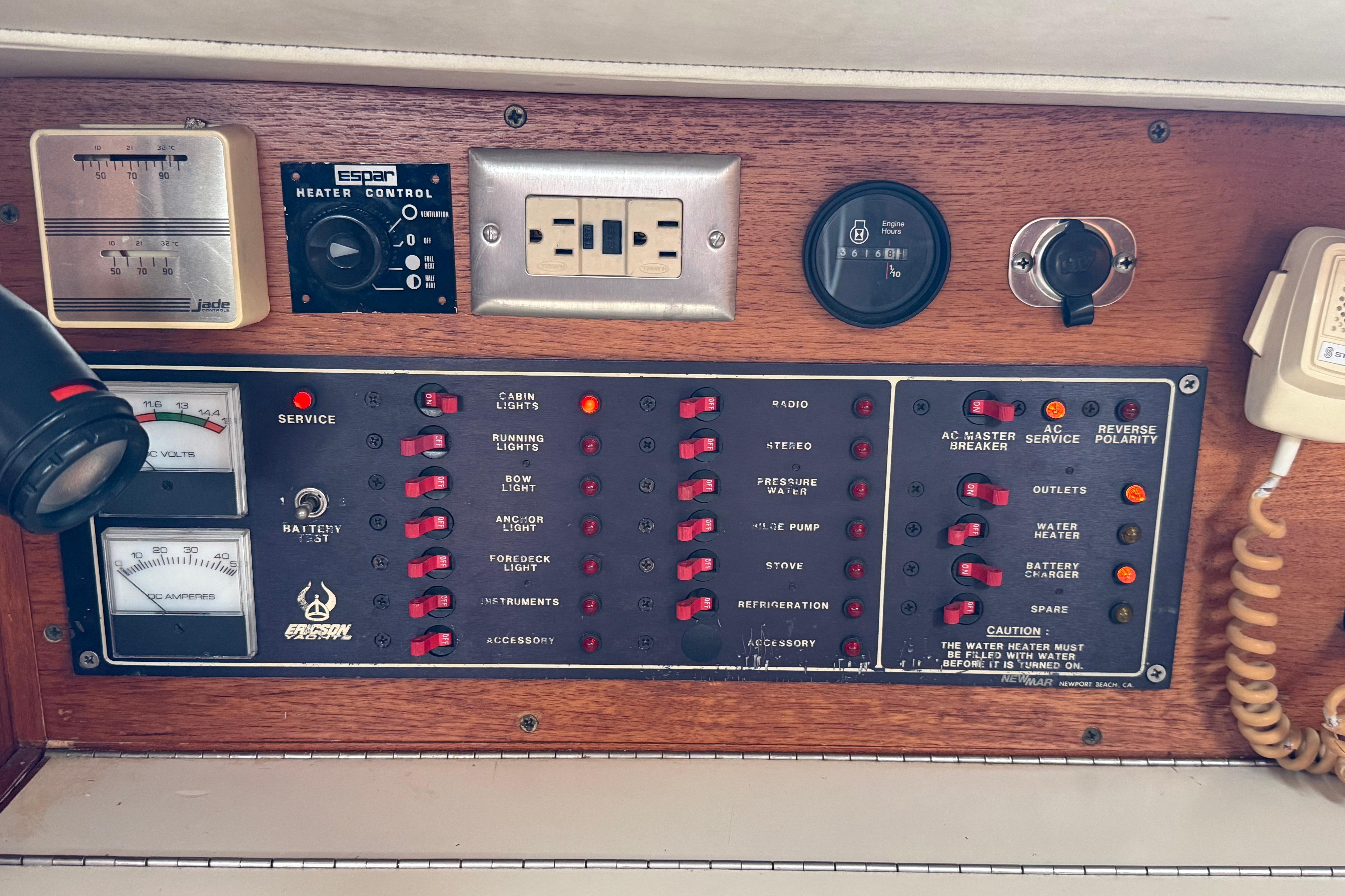 Control panel of a 1988 Ericson 32-200 sailboat with various switches and gauges.