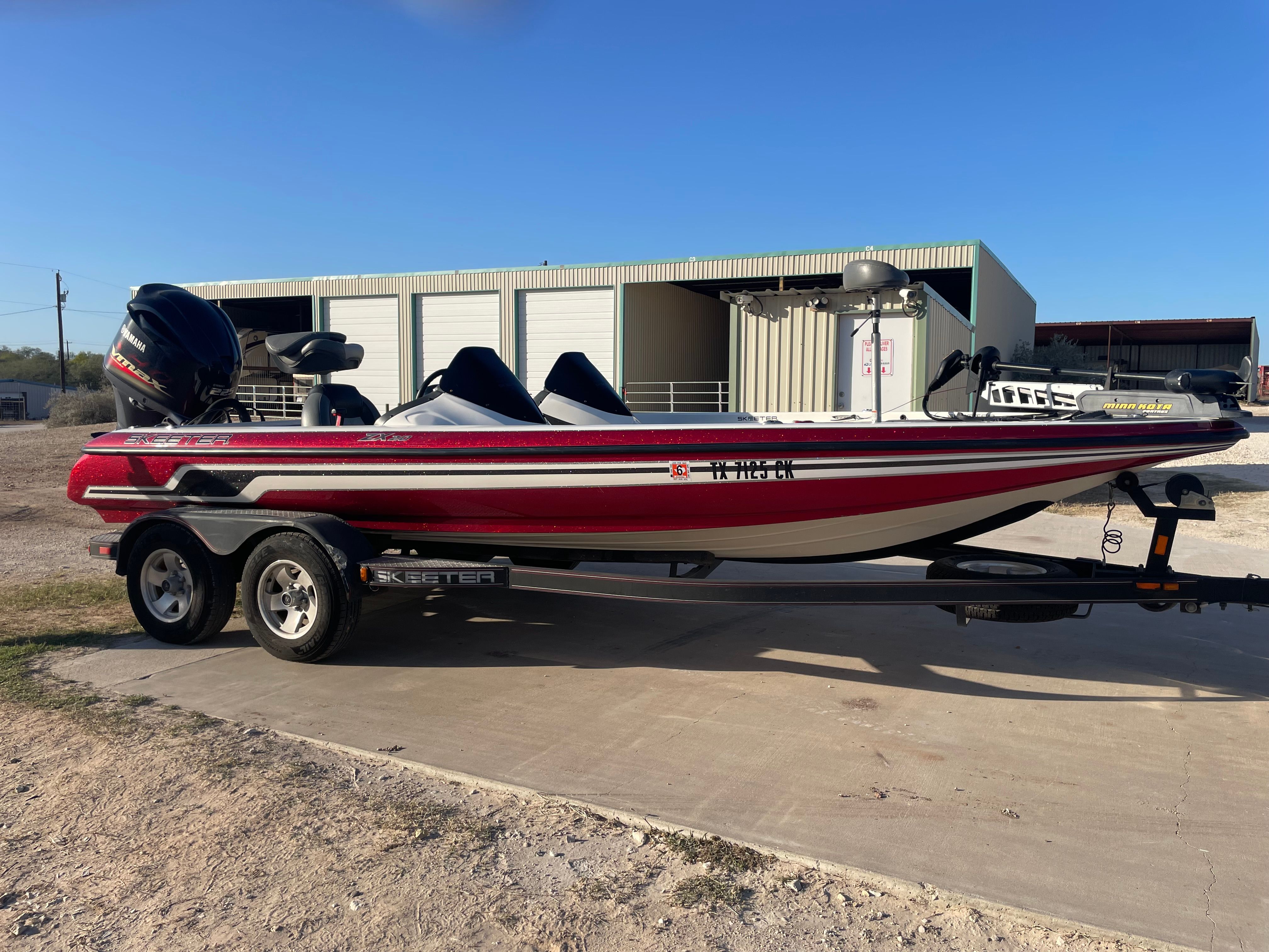 2012 Skeeter ZX20 boat on trailer in front of warehouse.