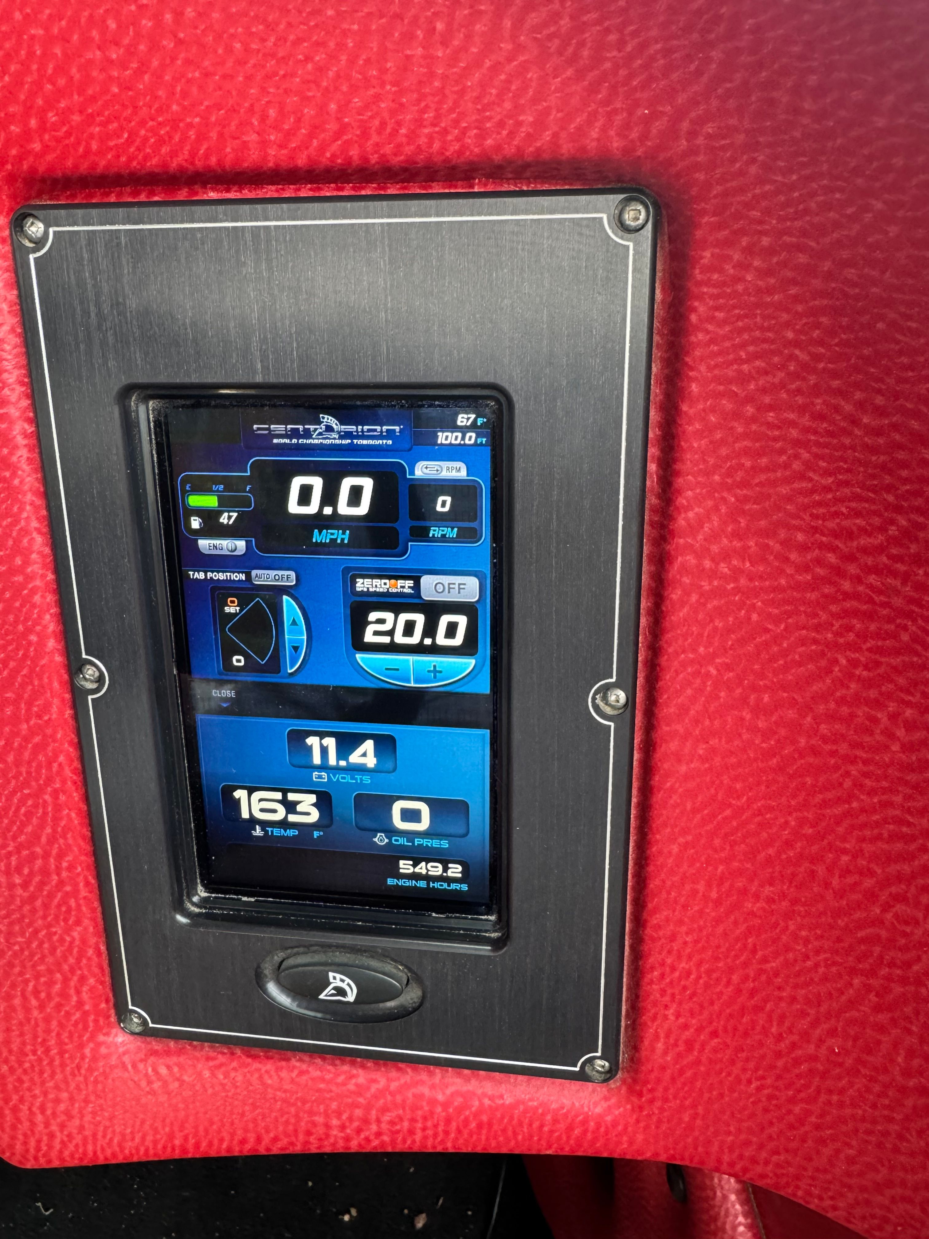 A digital dashboard displaying speed and engine data on a red background.