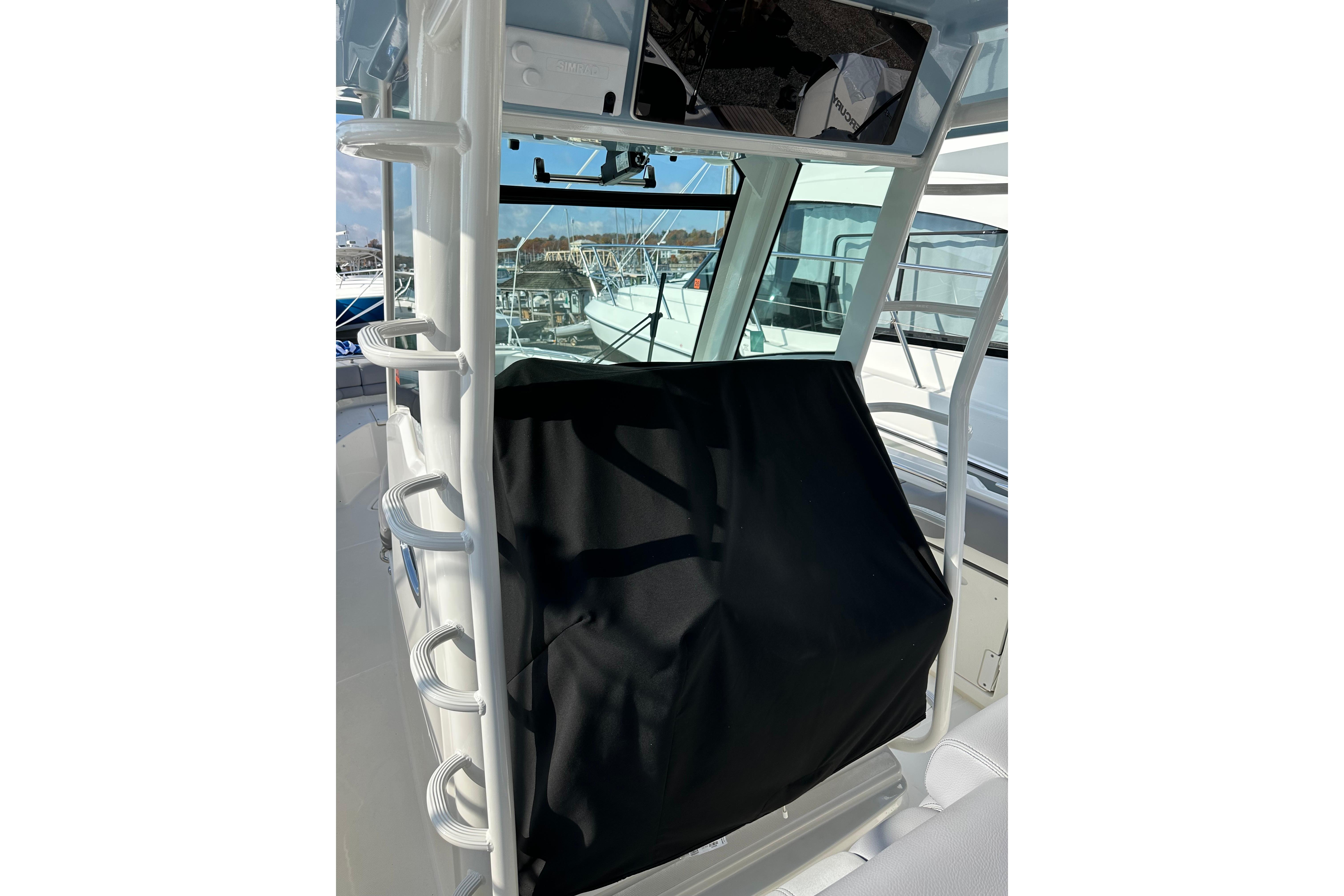 2023 Boston Whaler 330 Outrage helm station with protective cover.