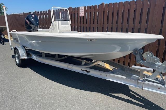 2026 Mako 18 Pro Skiff boat on trailer, parked outdoors.