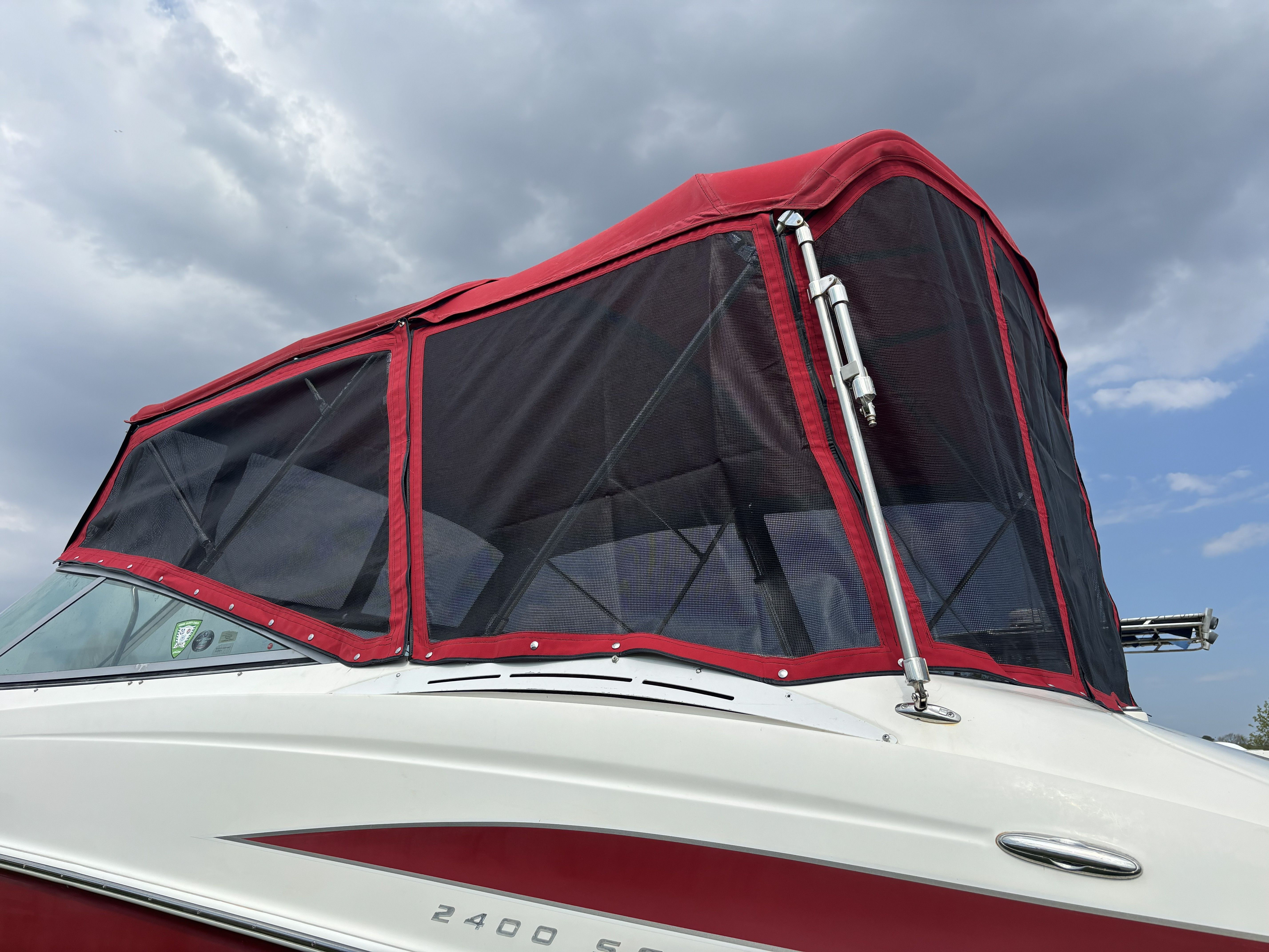 2005 Maxum 2400 SC3 boat with red canopy.