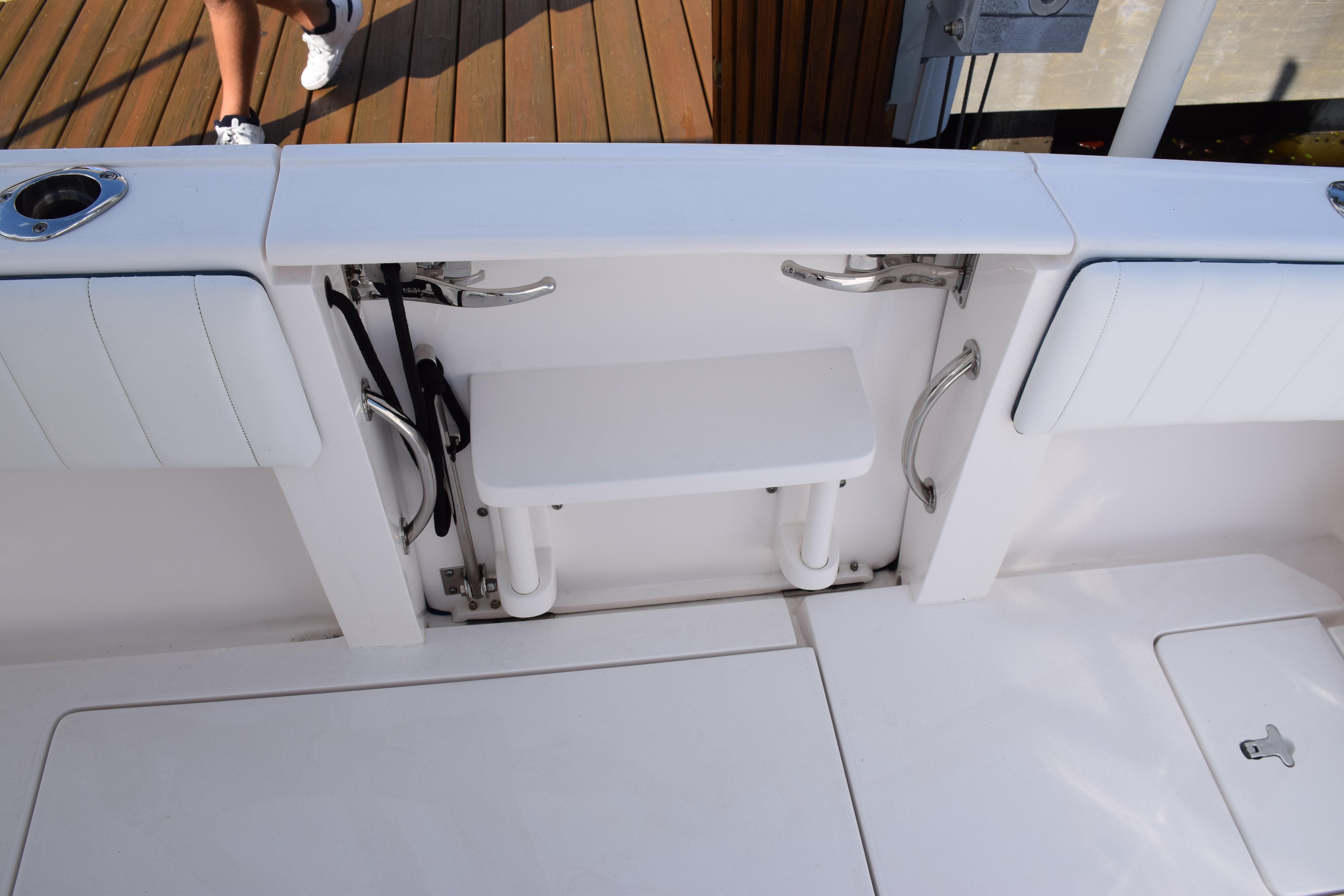 2017 Intrepid 327 boat deck with seating and storage compartments.