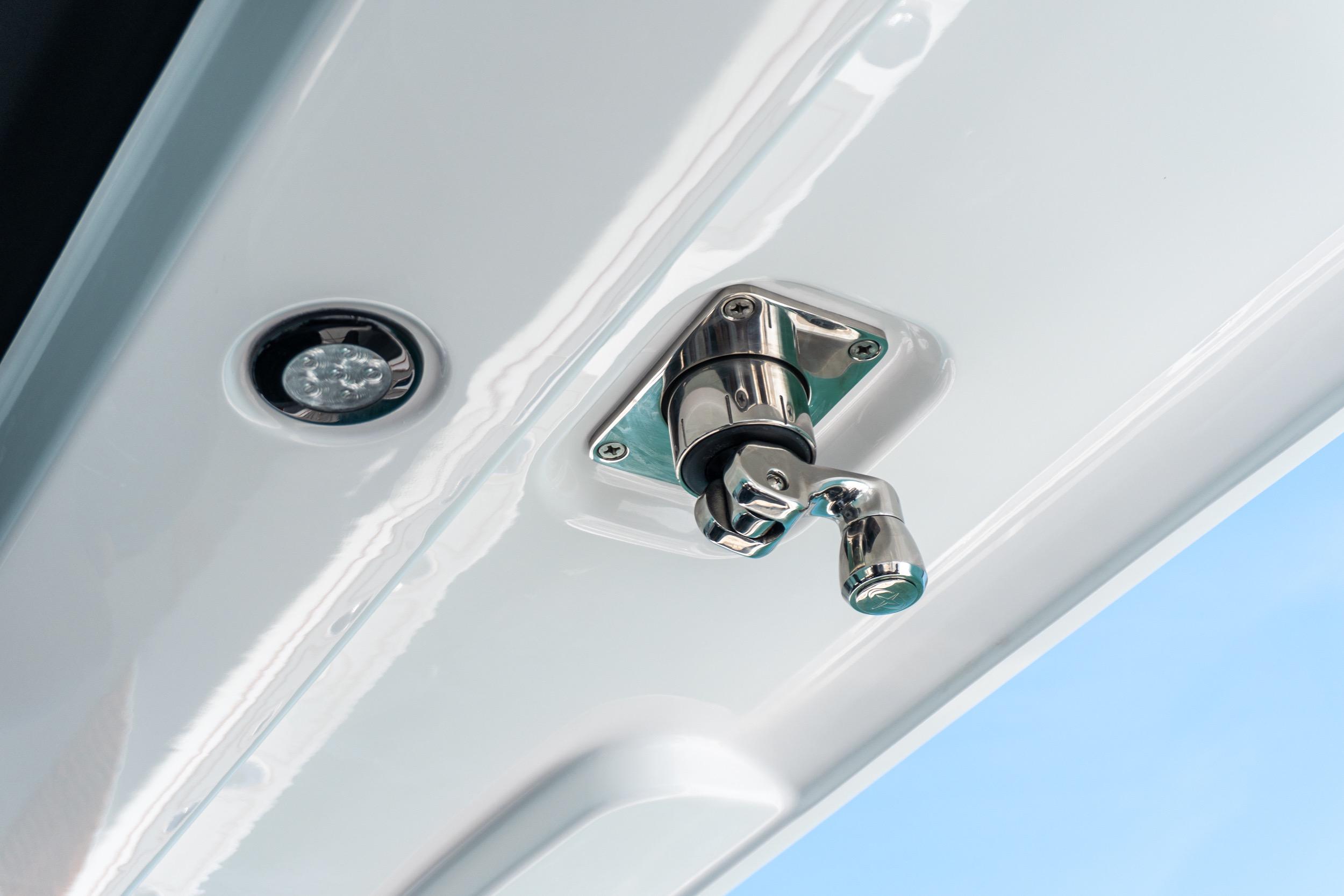 Close-up of a 2026 Twin Vee 400 GFX2 CC boat latch and light fixture.