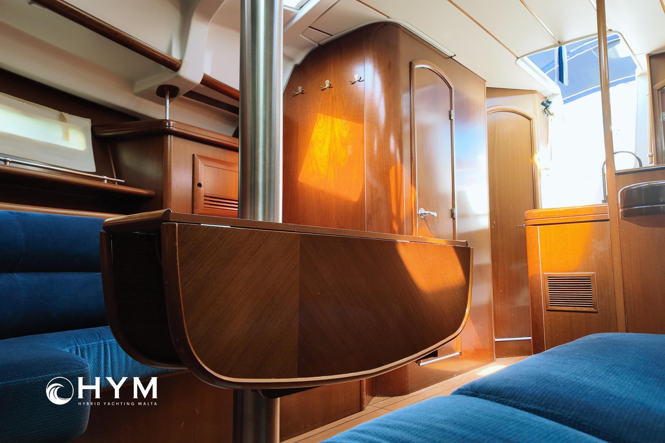 Interior of 2005 Beneteau Oceanis Clipper 373 yacht with wooden finishes and blue seating.