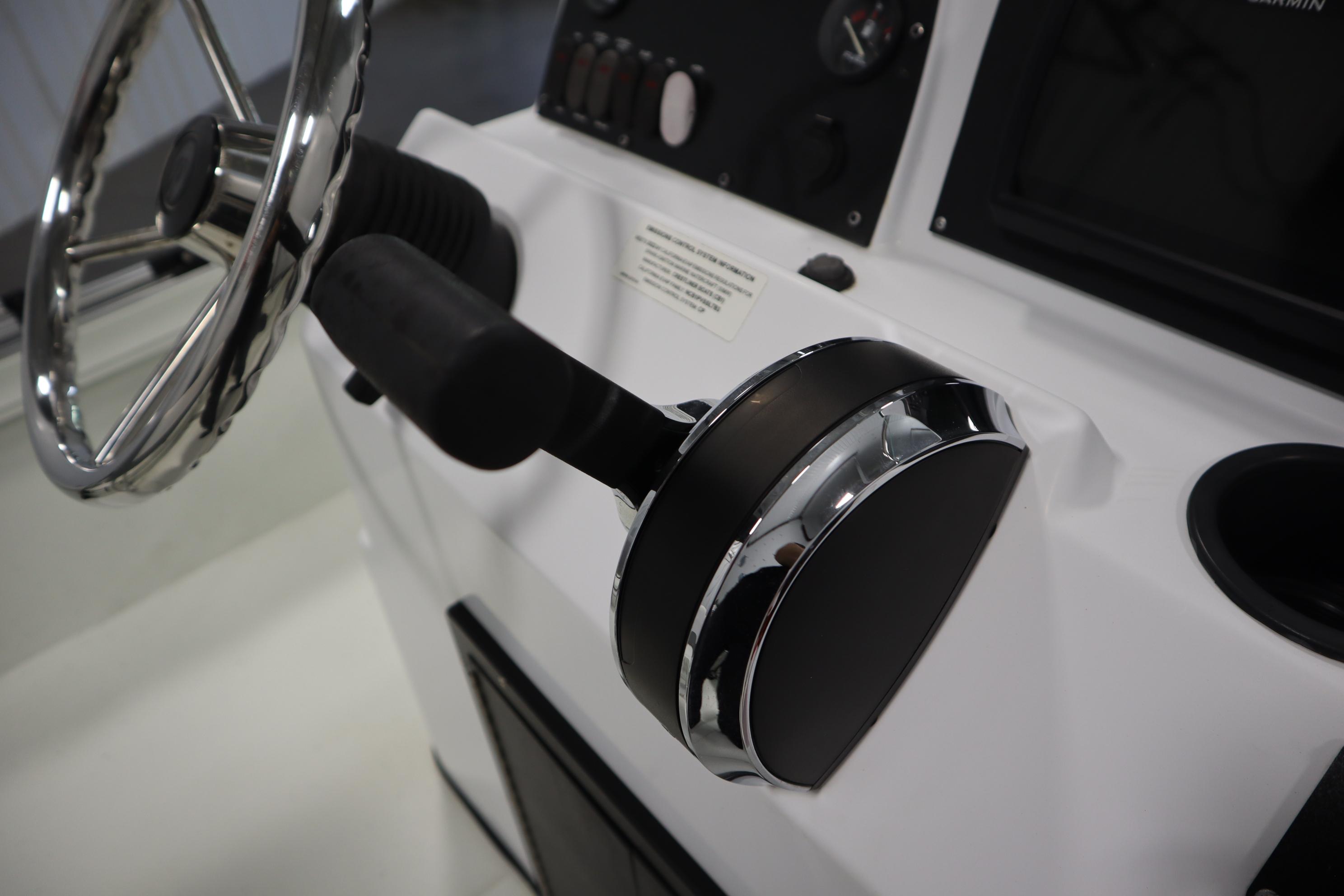 Steering console of 2022 Crestliner 2200 CC boat with chrome accents.