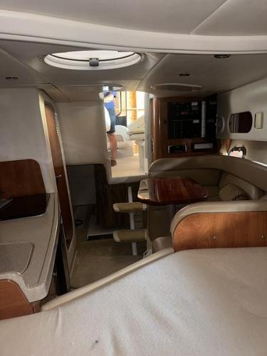 Interior of 2005 Four Winns 298 Vista boat with seating and wood accents.