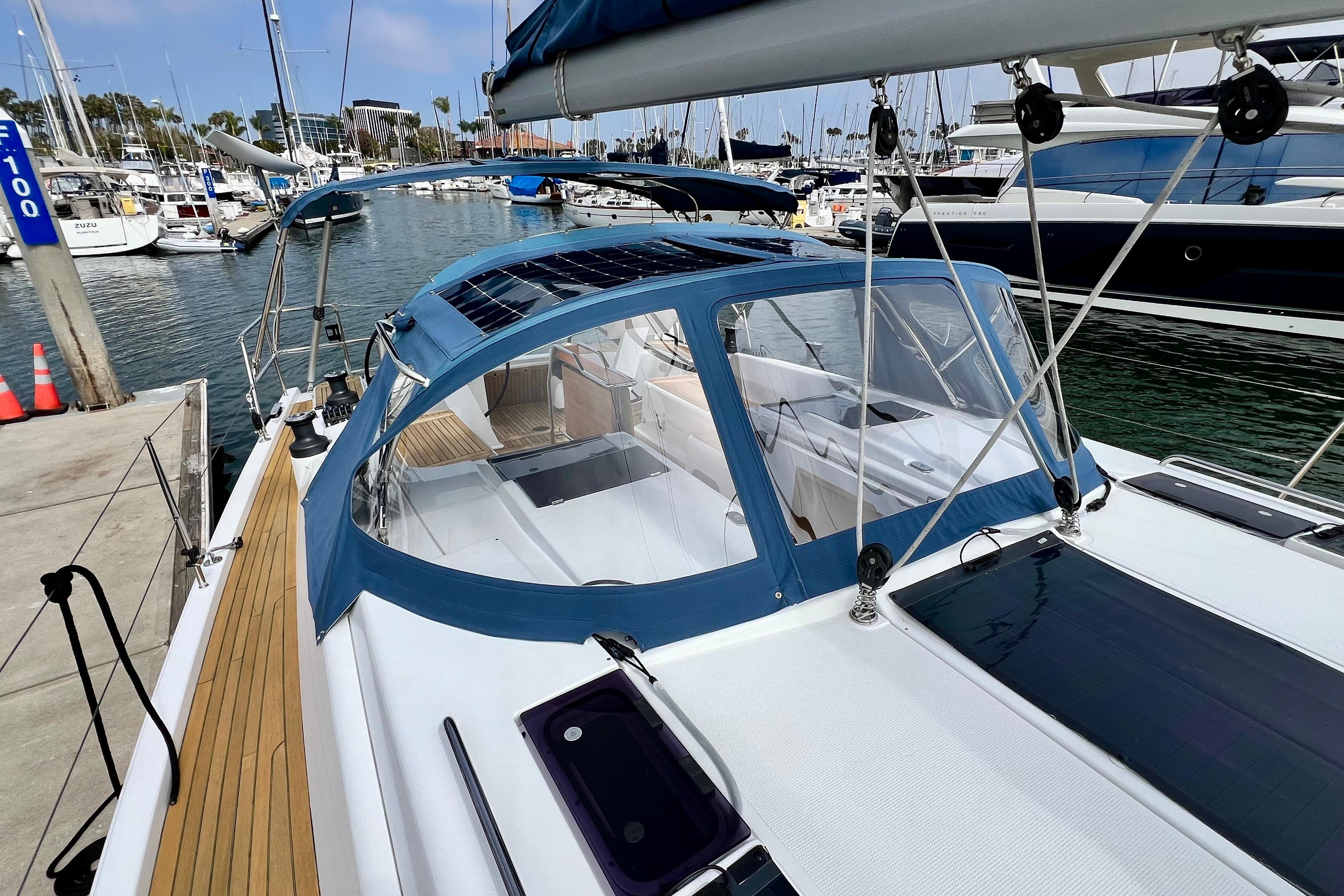 2016 Hanse 455 sailboat docked at marina, featuring sleek design and blue canopy.