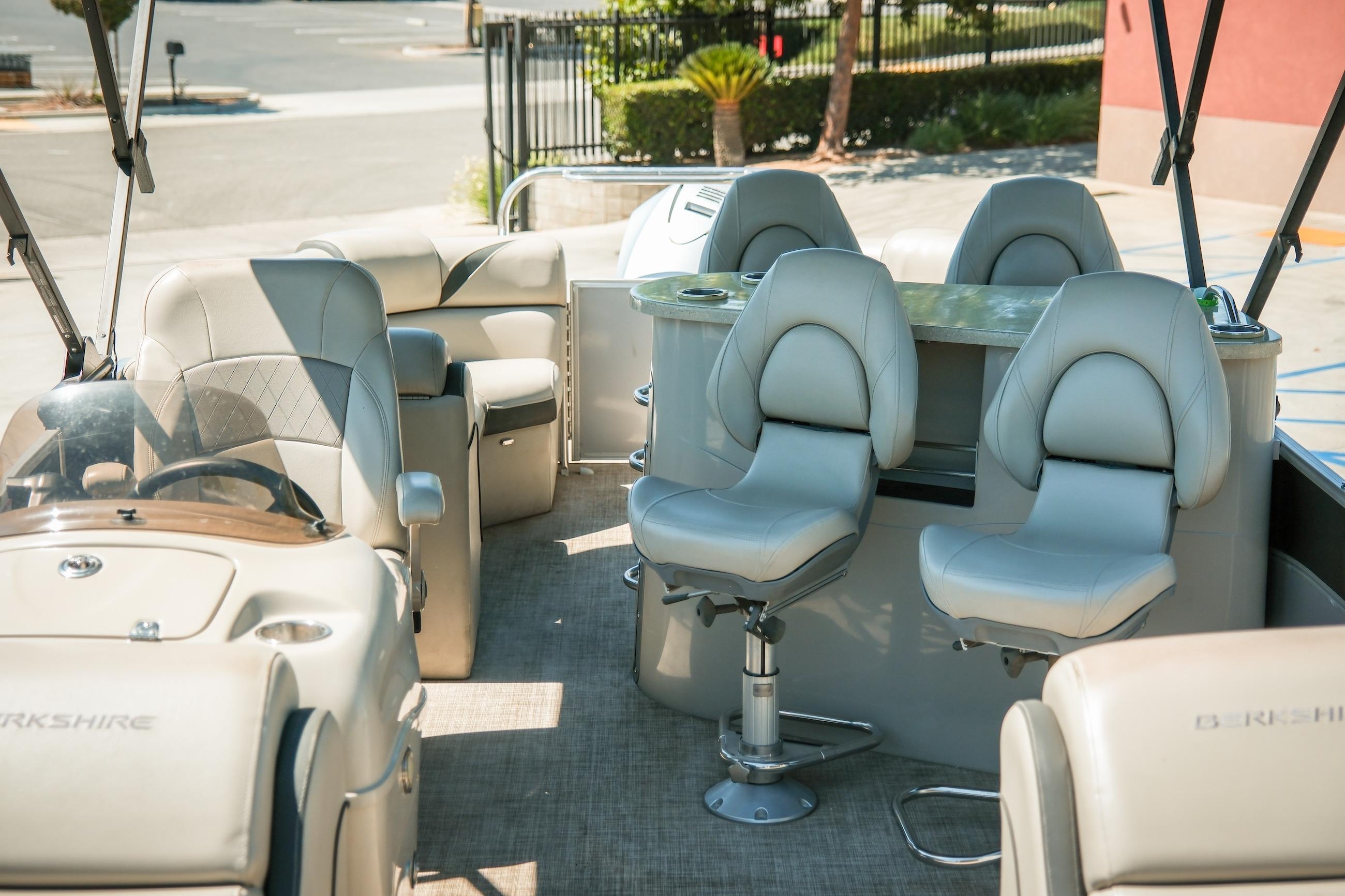 Interior of 2019 Berkshire 25CLE STS pontoon boat with plush seating and helm.