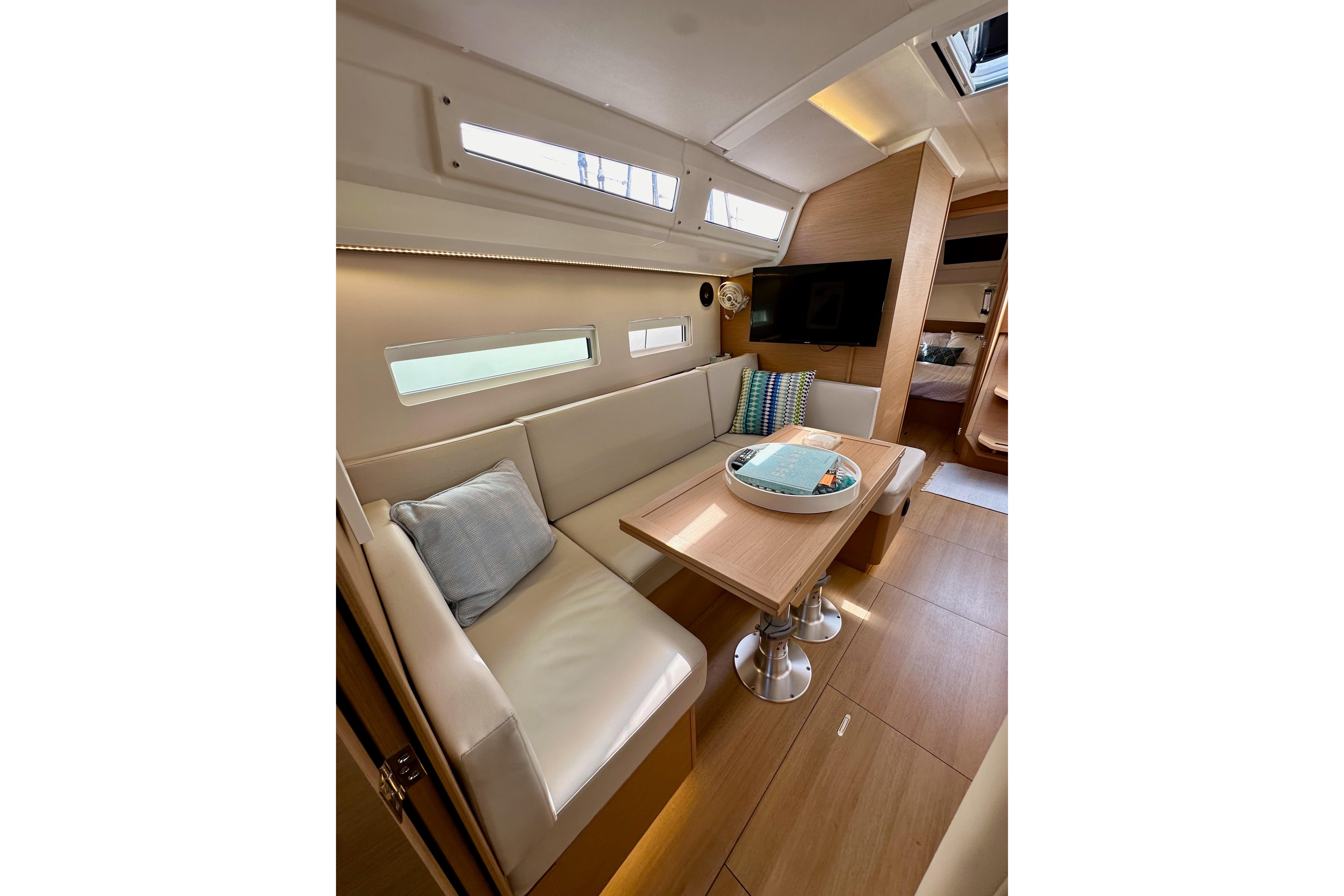 2024 Jeanneau Sun Odyssey 410 interior with cozy seating and modern design.