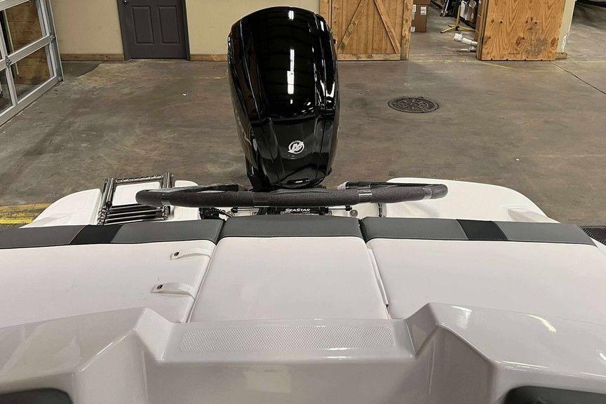 2026 Tahoe T16 boat with a sleek black motor in a garage setting.
