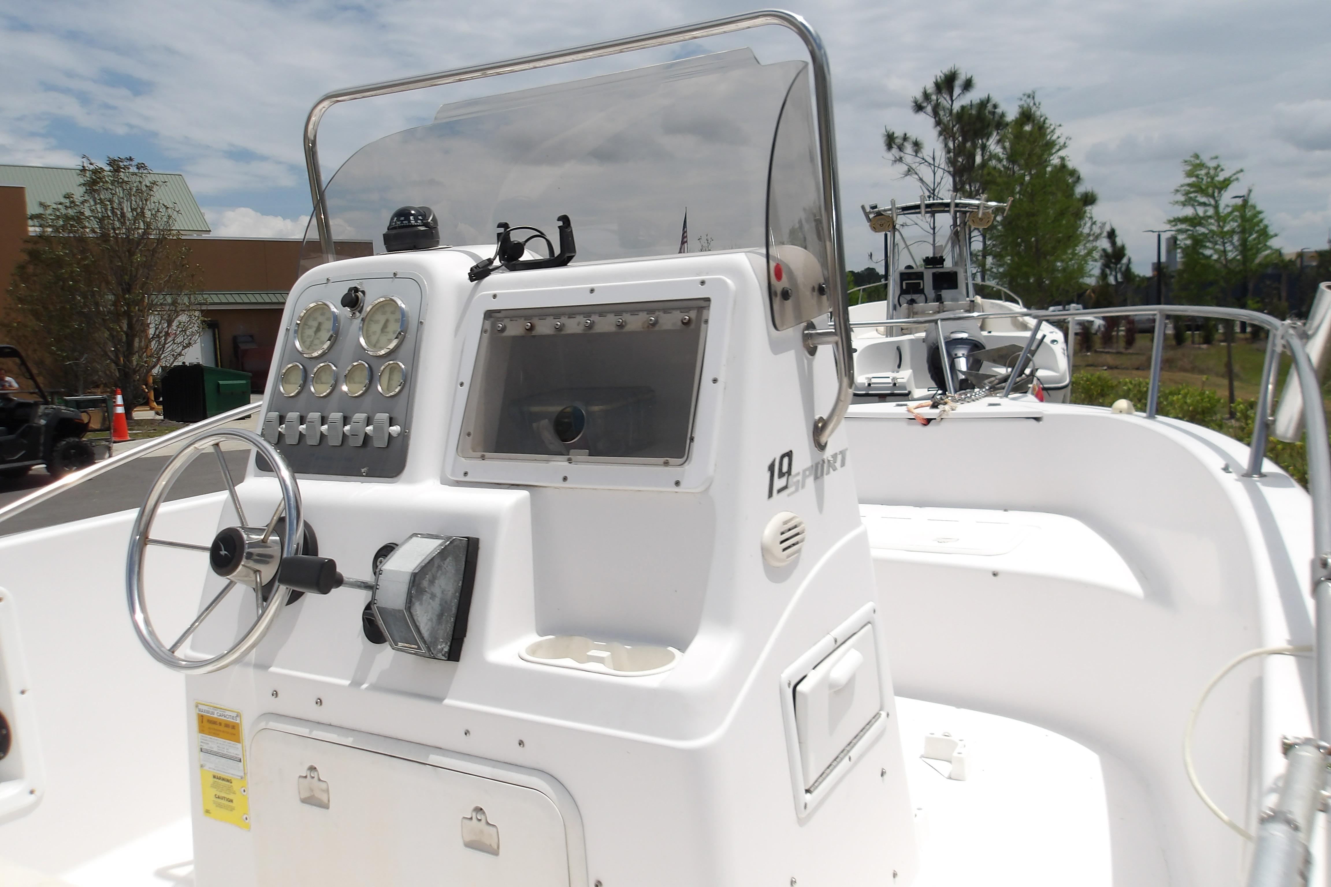 2000 Pro-Line 19 Sport boat dashboard with steering wheel and gauges, outdoors.
