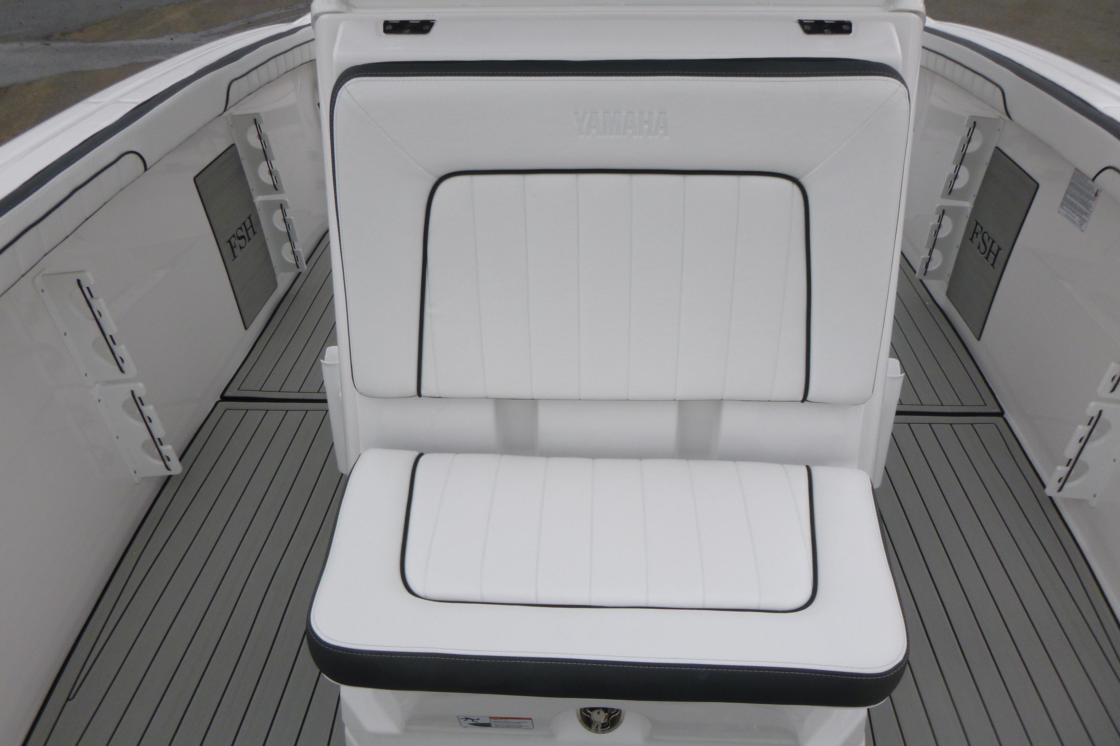 2026 Yamaha Boats 255 FSH Sport H interior with white cushioned seating.