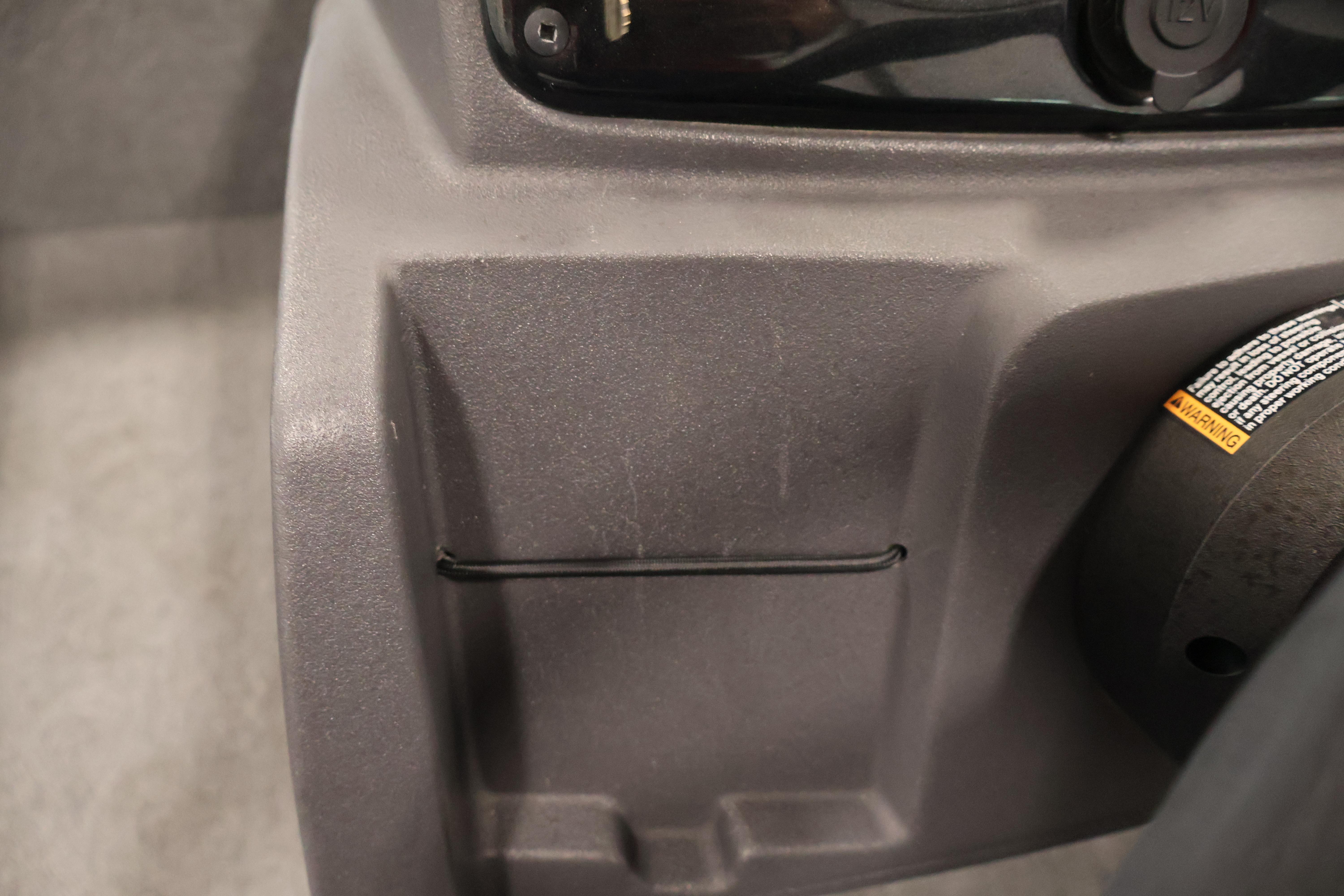 2024 Tracker Pro 170 interior detail with warning label and storage compartment.