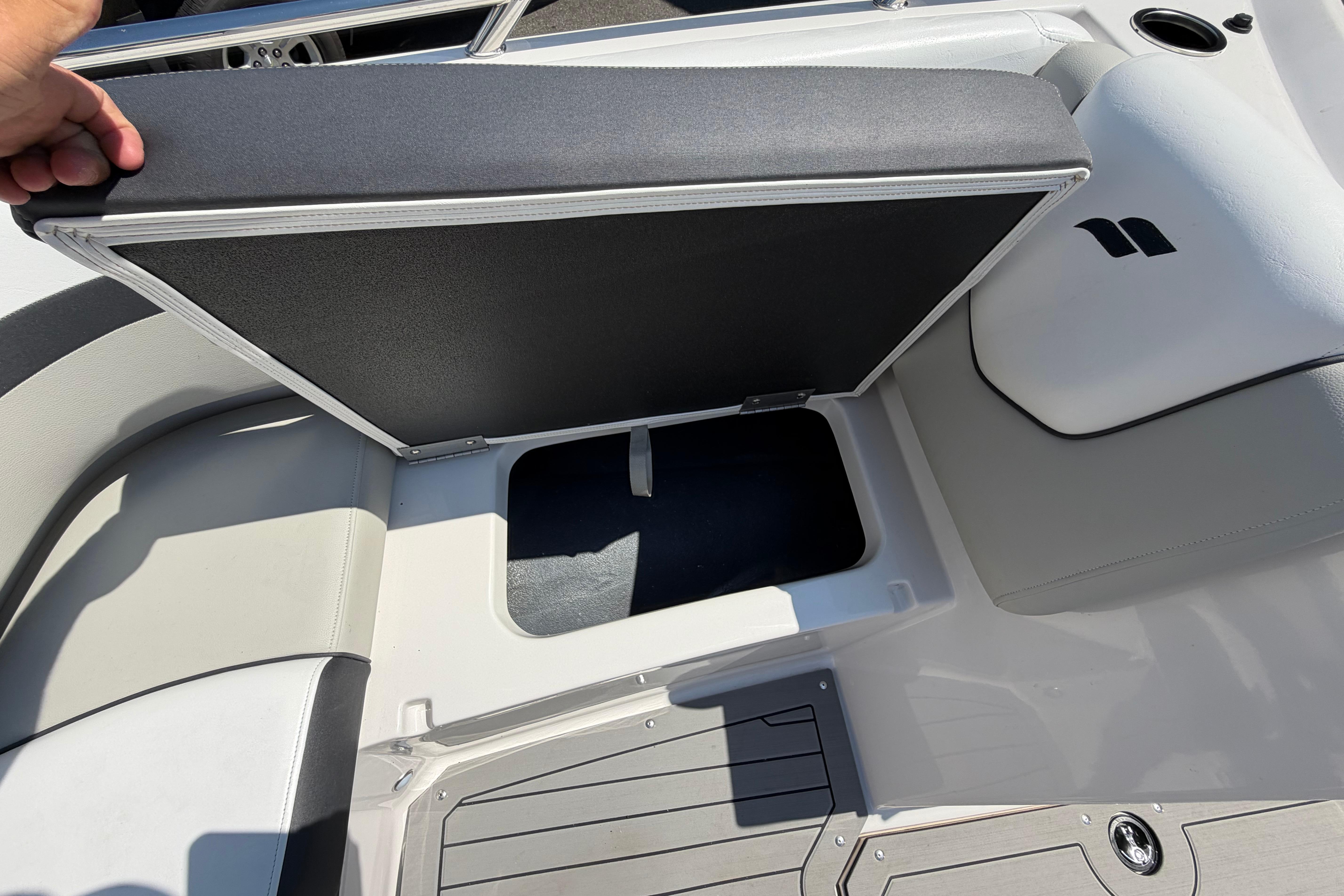 2025 Starcraft SVX 190 OB boat seat storage compartment open, showcasing interior space.