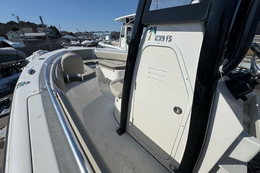 2026 Key West 239 FS boat interior with seating and console, docked outdoors.