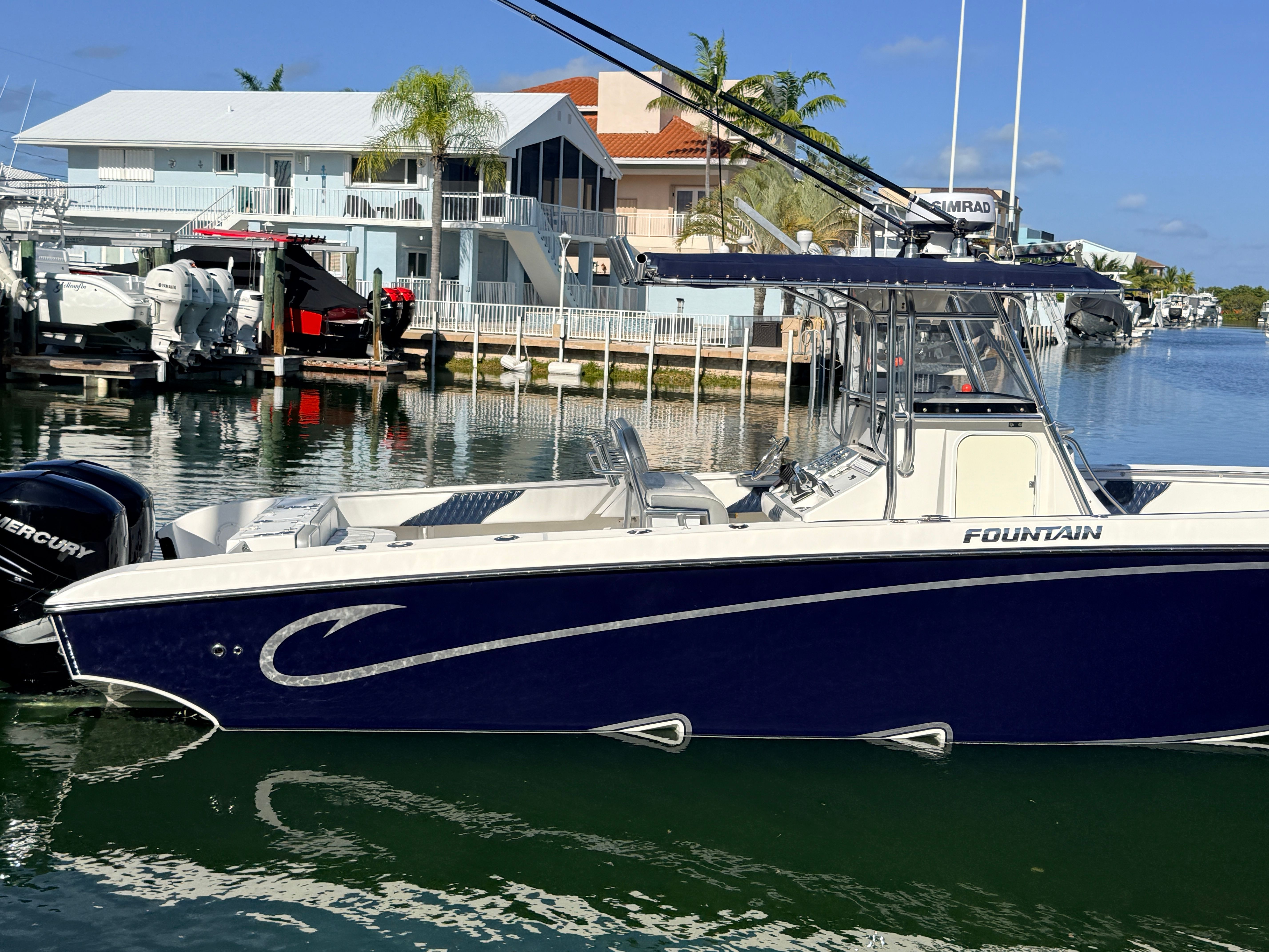 2007 Fountain 32 Center Console boat docked in harbor.