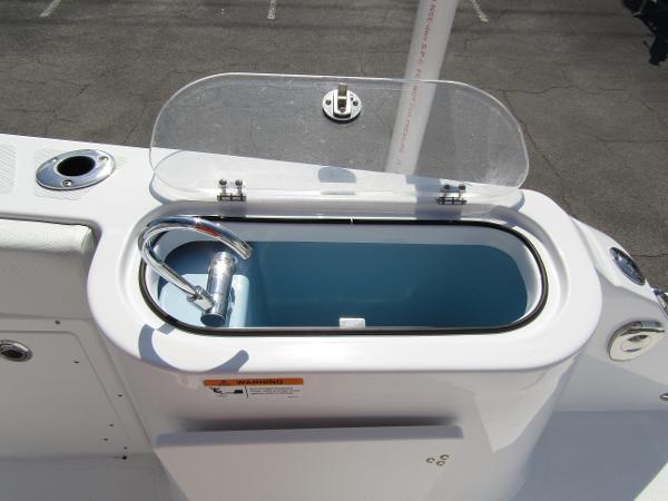 Livewell on 2024 Wellcraft 263 Fisherman boat with open lid and hose.