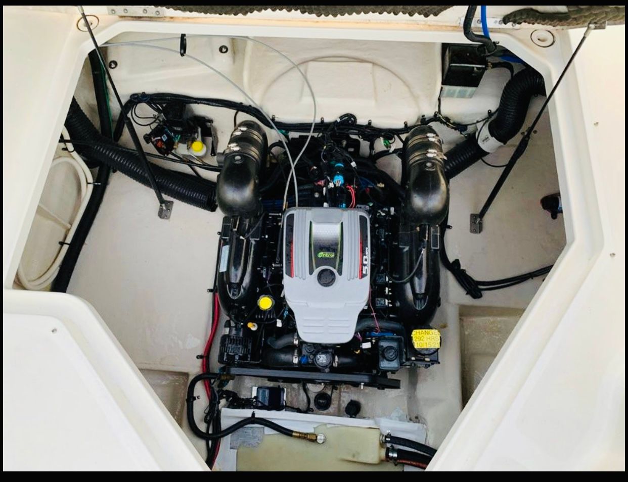 Engine compartment of a 2012 Sea Ray 240 Sundancer boat, showcasing the motor and components.
