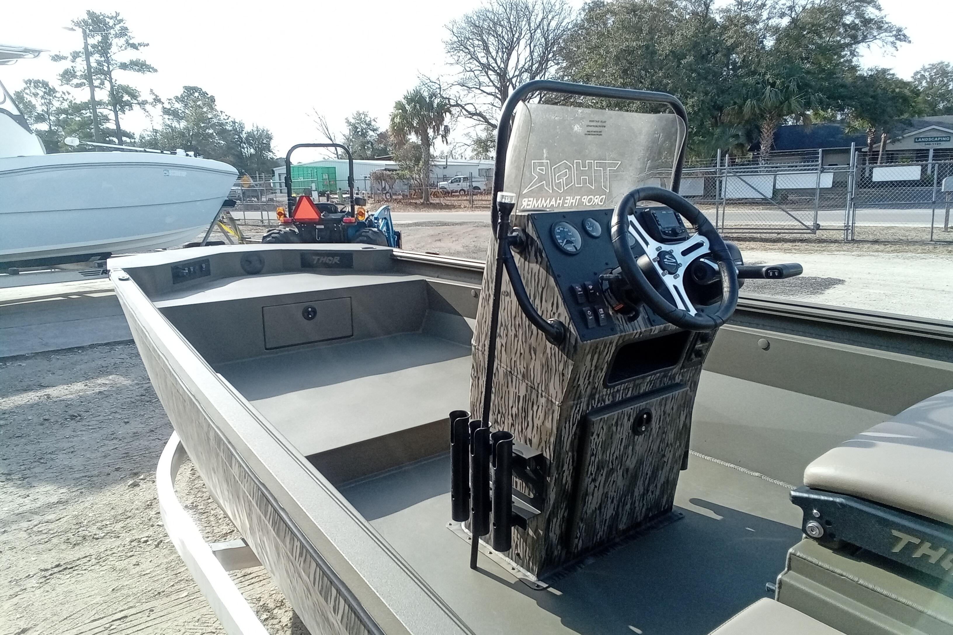 2026 Thor 1900 Low Country Elite boat with camo console and steering wheel.