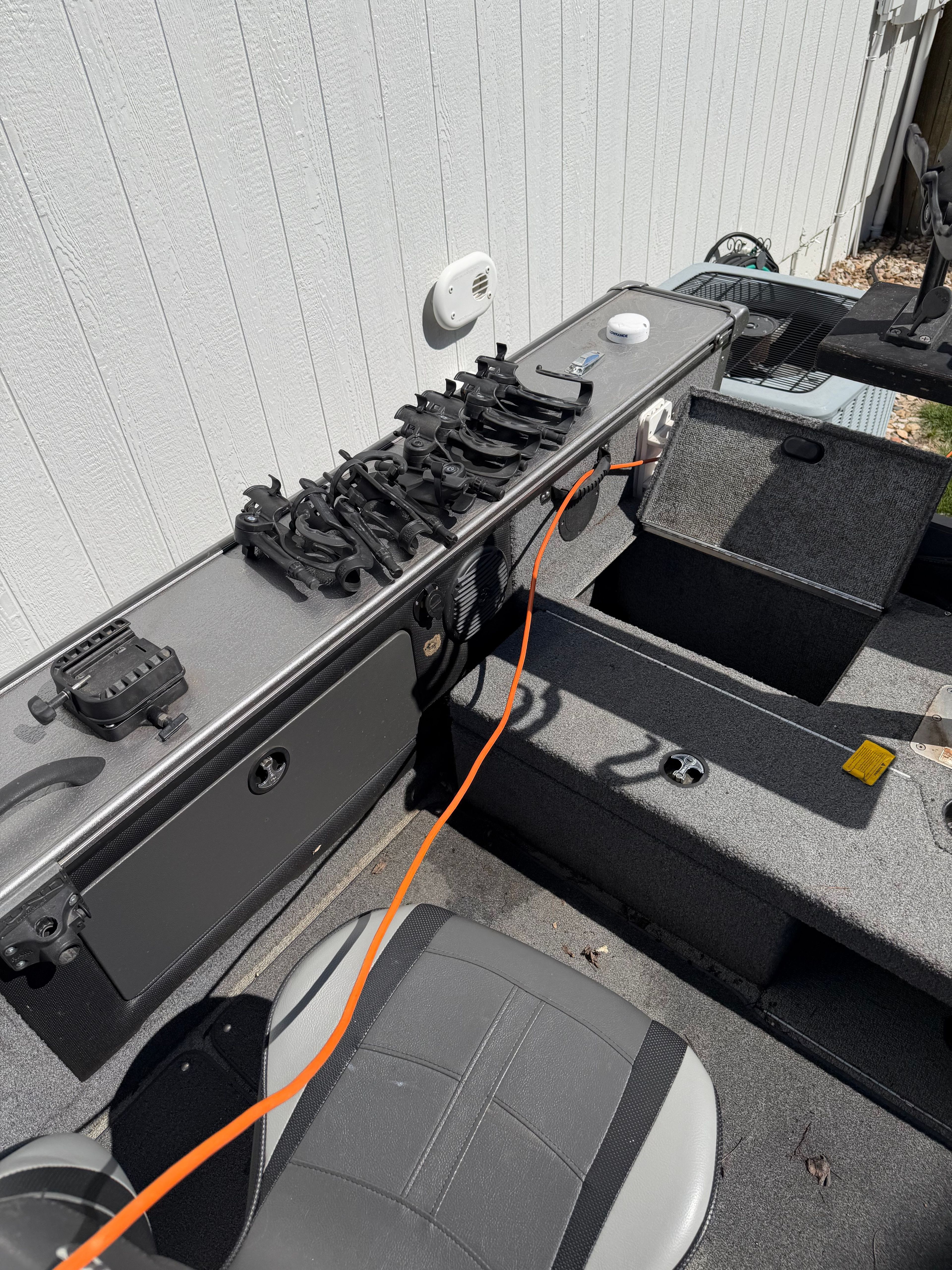 Interior view of a 2017 Lund Pro V 1975 boat with fishing rod holders.
