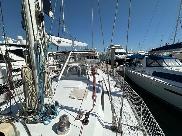 1989 Concordia 52 sailboat docked at a marina, surrounded by other boats.