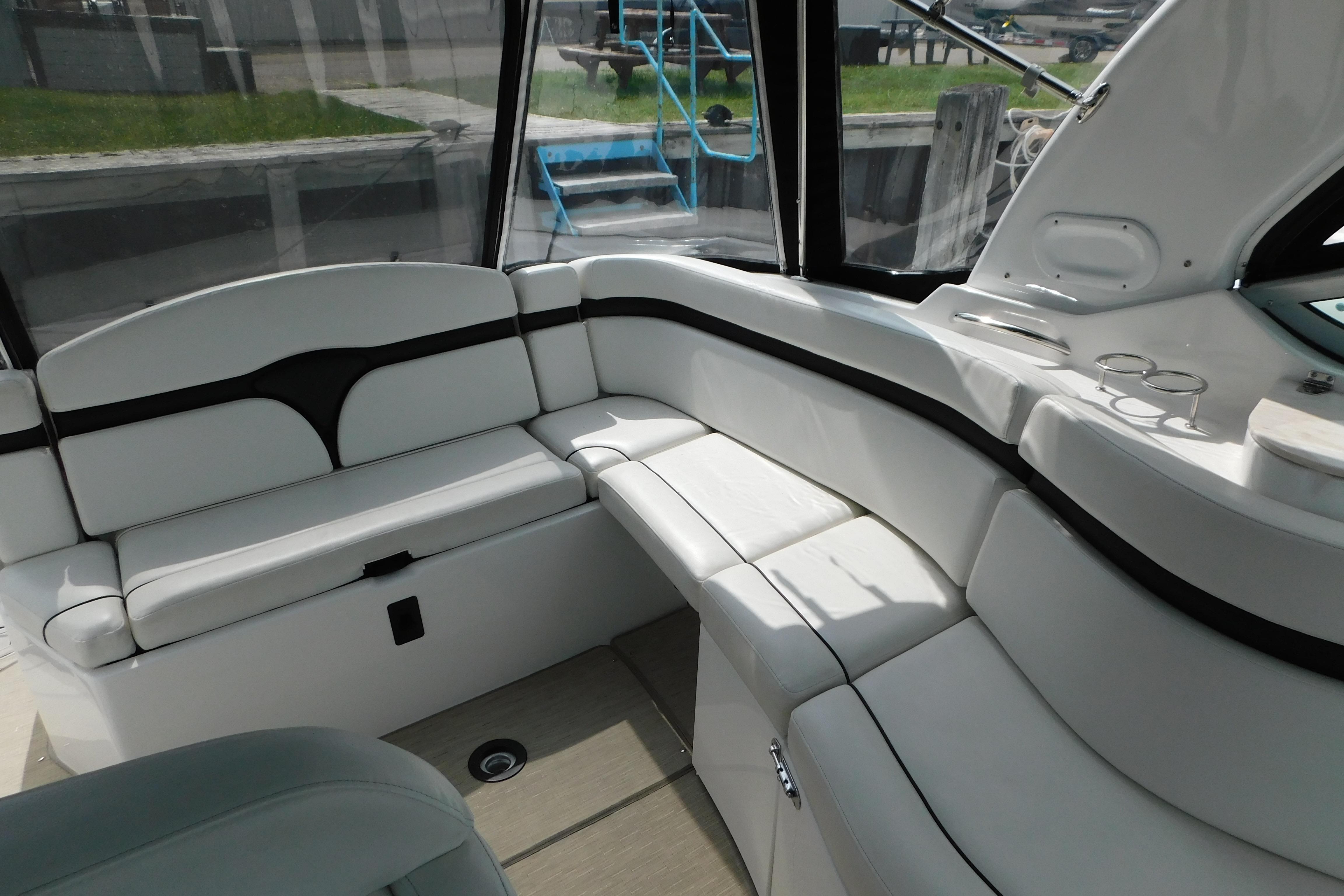2017 Rinker EX 320 boat interior with white seating and cup holders.