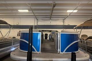 2026 Sun Tracker Party Barge 22 DLX pontoon boat in indoor storage.