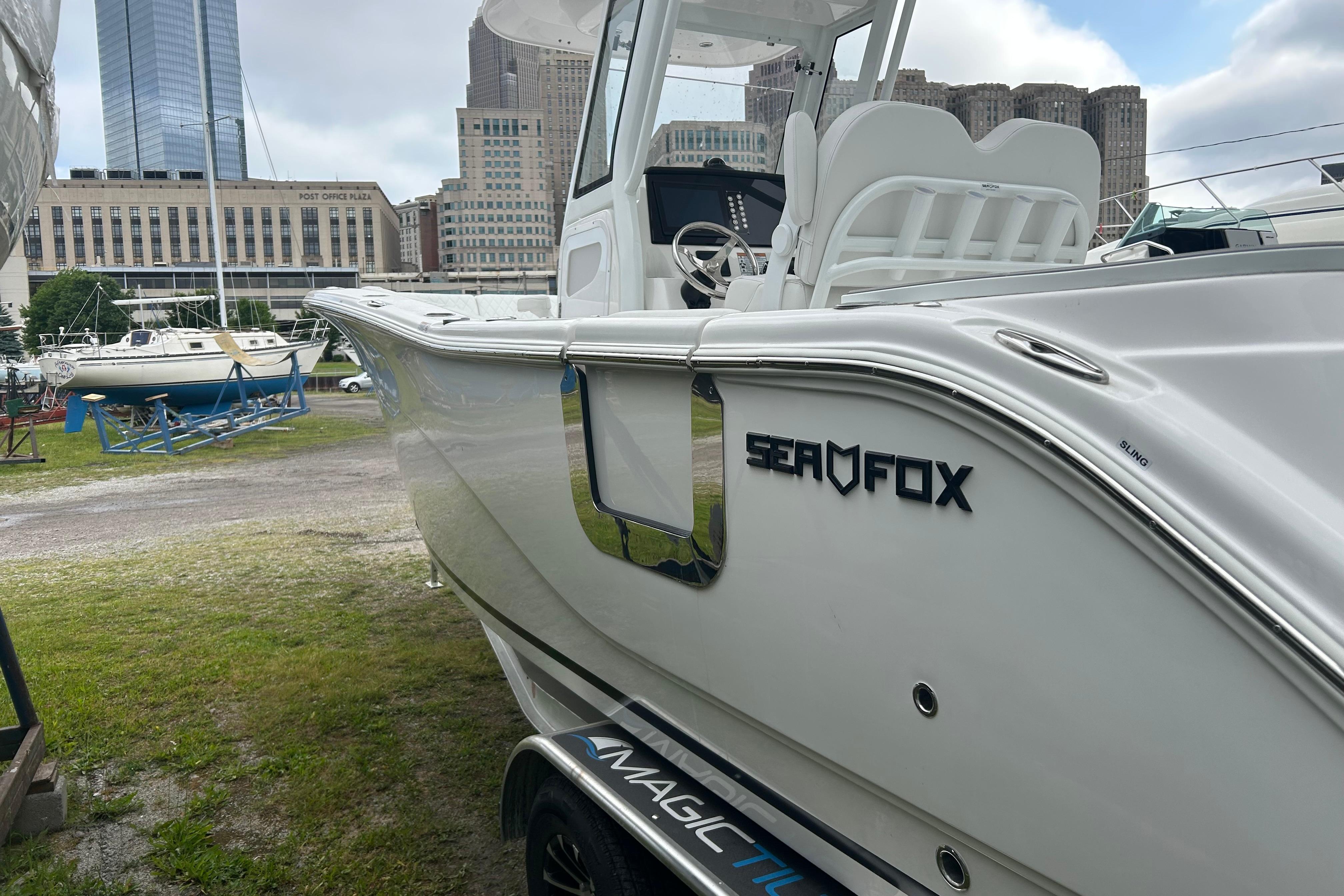 2026 Sea Fox 268 Commander boat docked near city buildings.