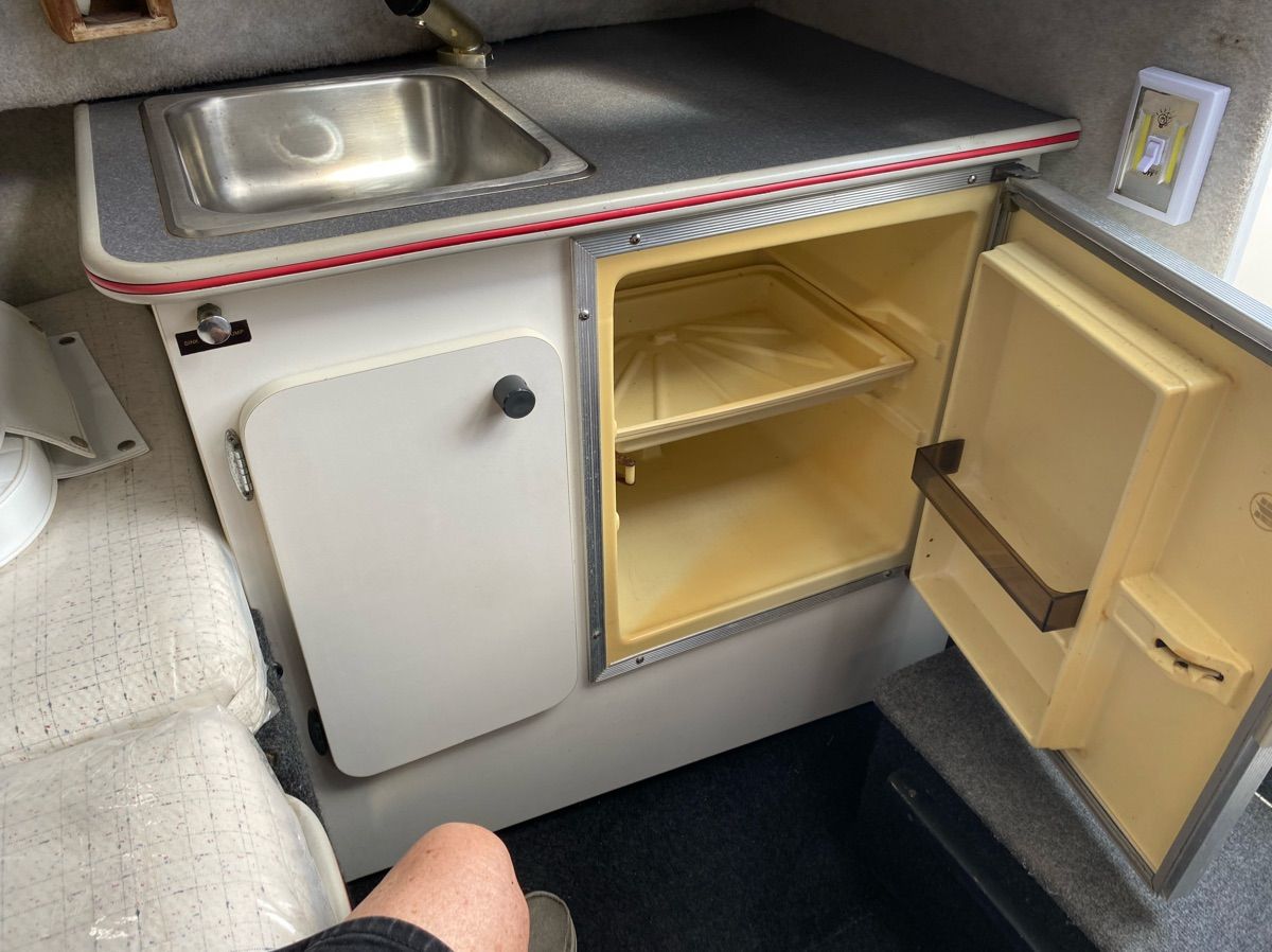 Interior of 1990 Bayliner 2302 Trophy with sink and fridge.